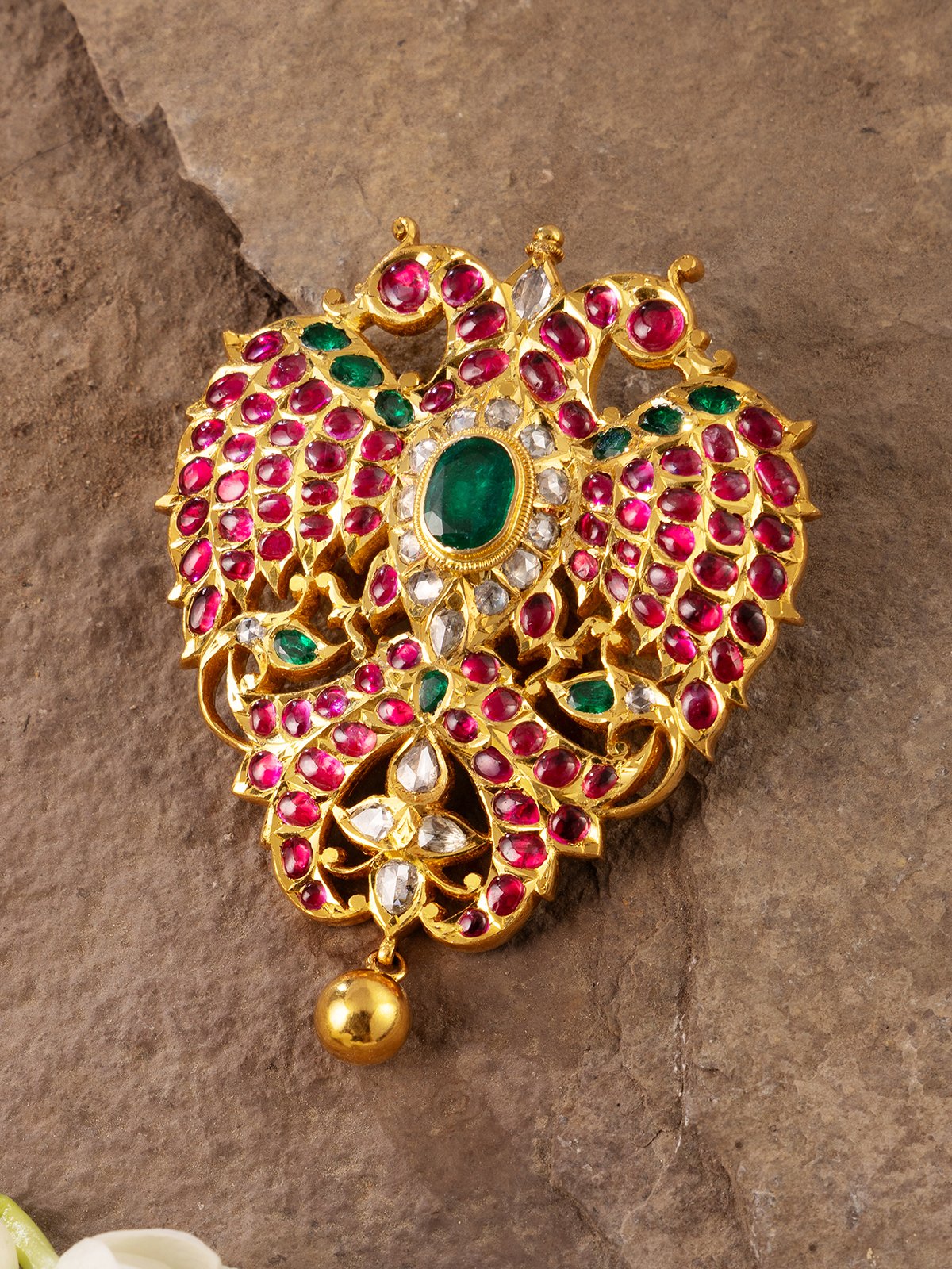 Close-up image focusing on artisan gold smithing details of the brooch