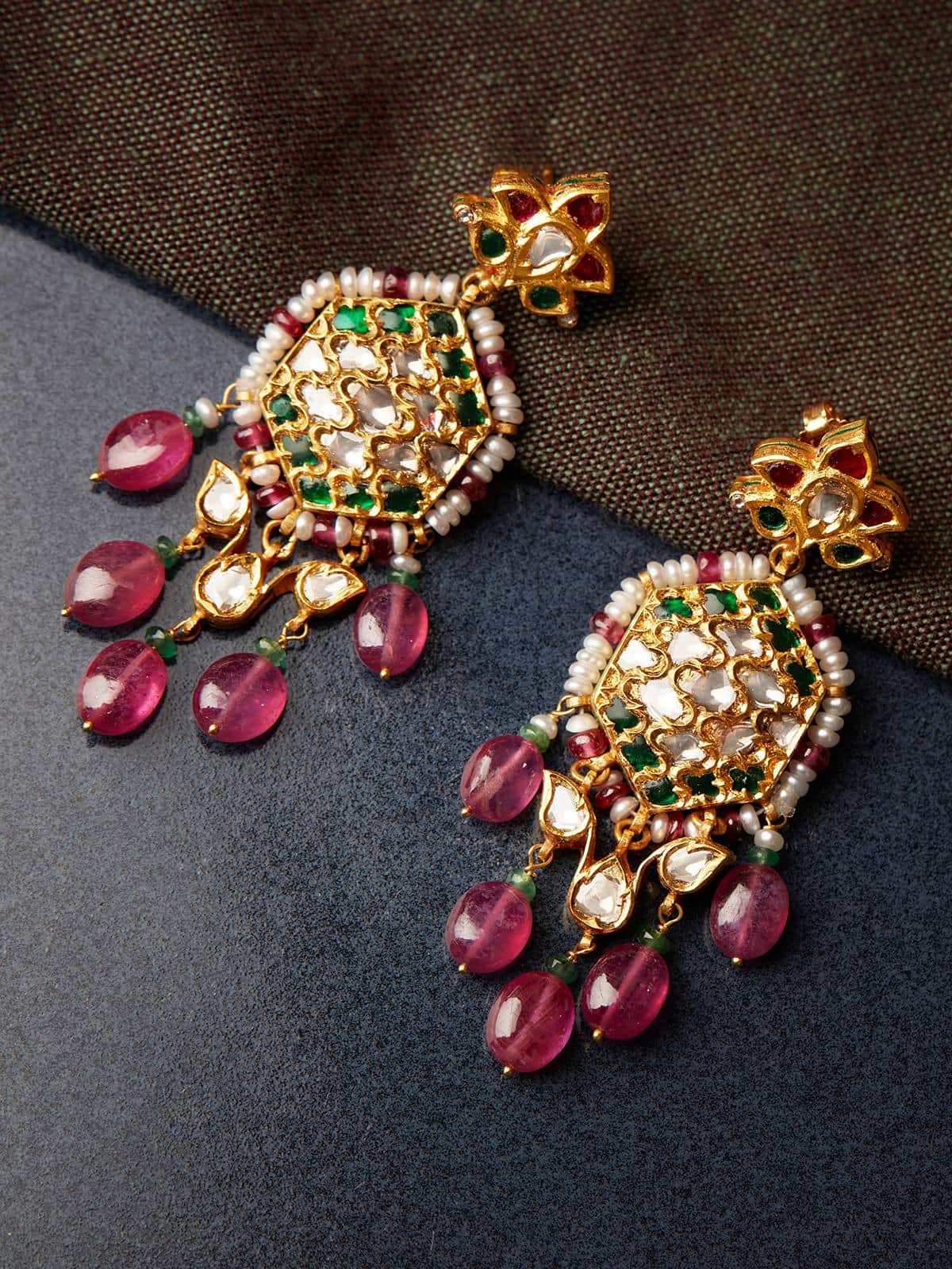Angled view of Badroom 22 Karat Gold Drop Earrings showcasing their luxurious gold and design.