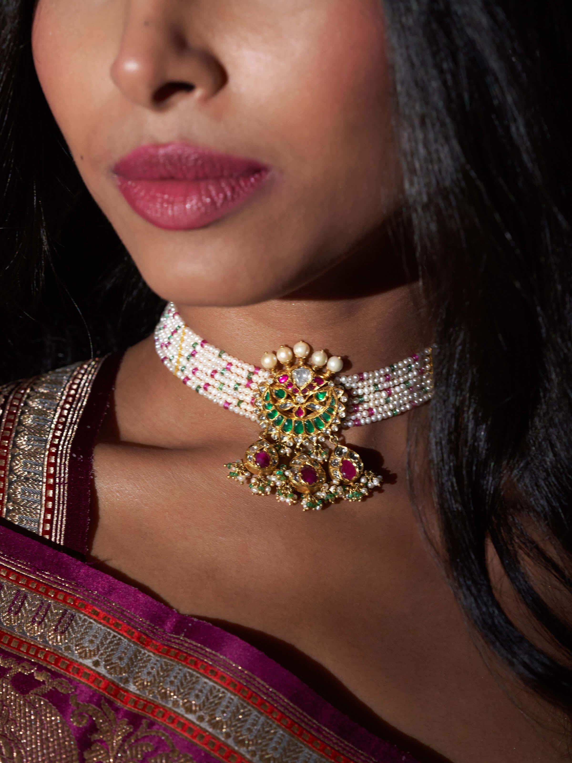 Alternate lifestyle shot of Jadau gold choker styled for wedding look with rich embellishment.