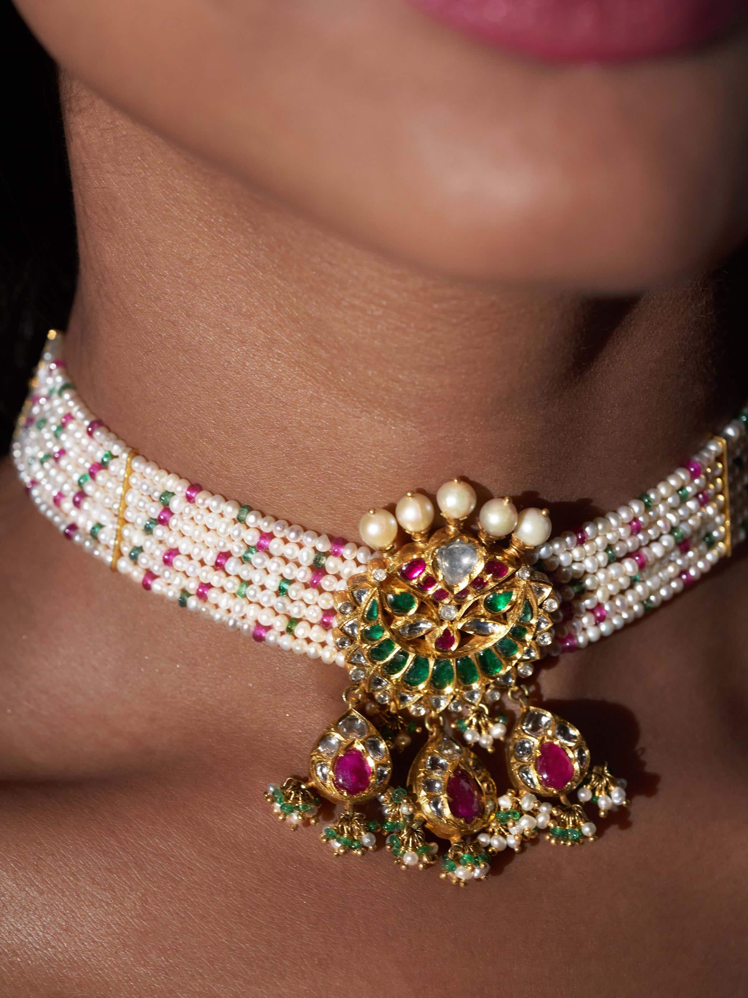Detail view of Jadau gold choker showcasing intricate goldwork and polki stone embellishments.
