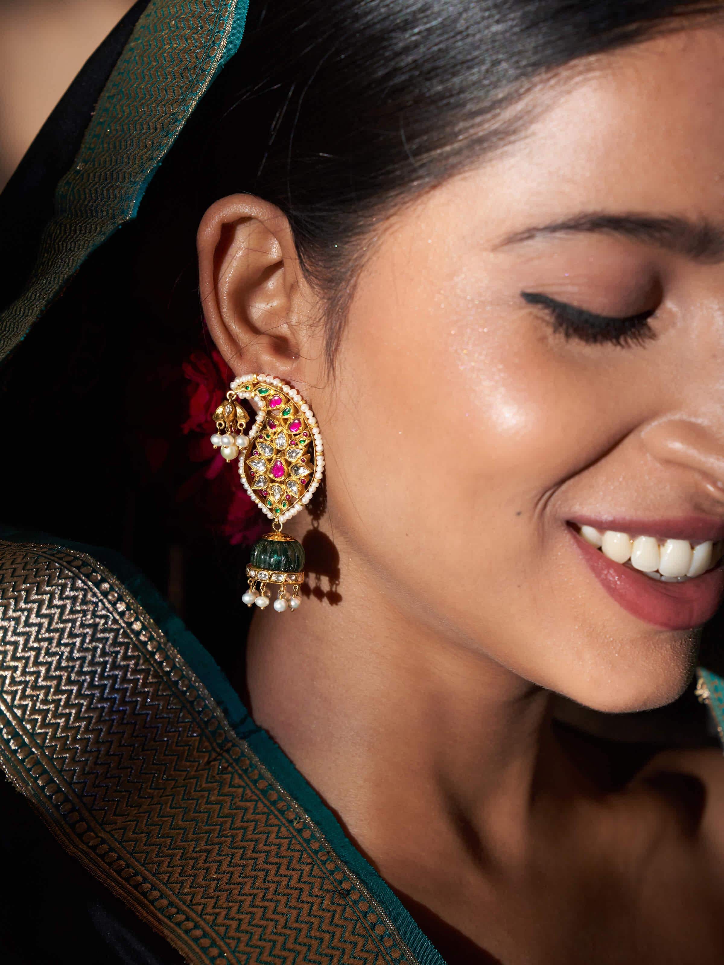 Angled lifestyle shot highlighting detailed craftsmanship of jhumkas