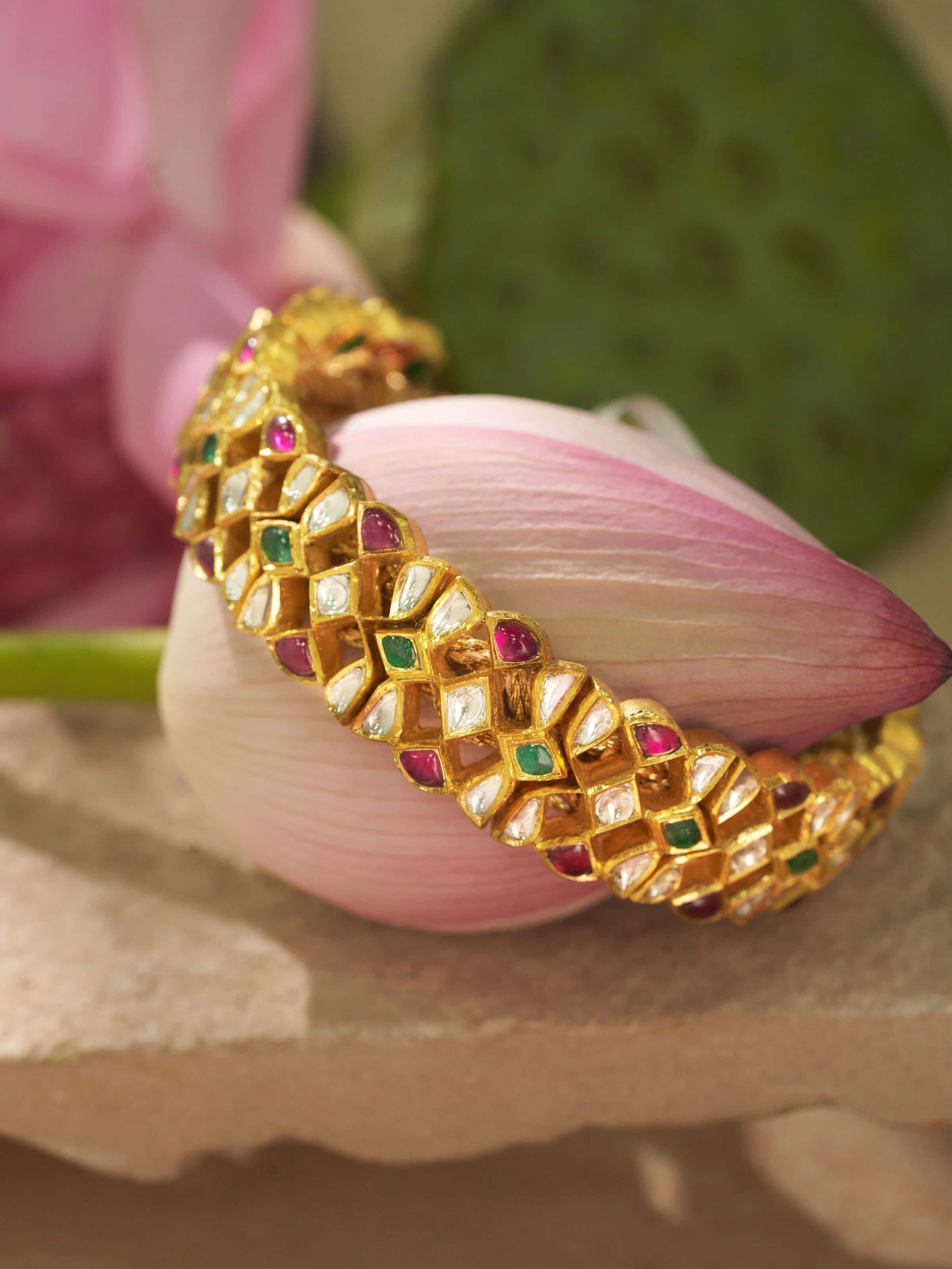 Side view of Jadau 18 karat gold bracelet highlighting intricate goldwork and details
