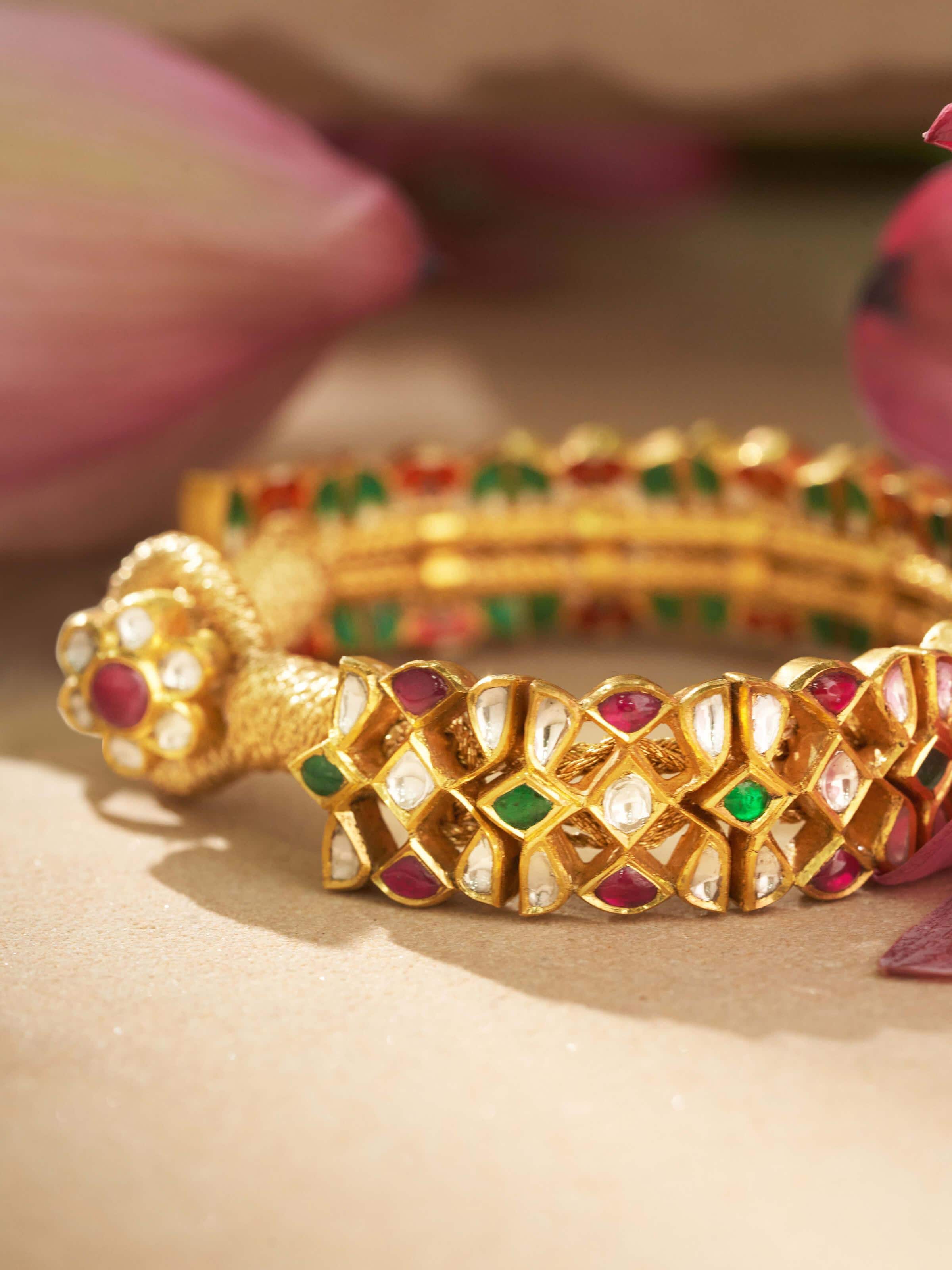 Angled view of Jadau 18 karat gold bracelet showcasing elegant design and goldwork