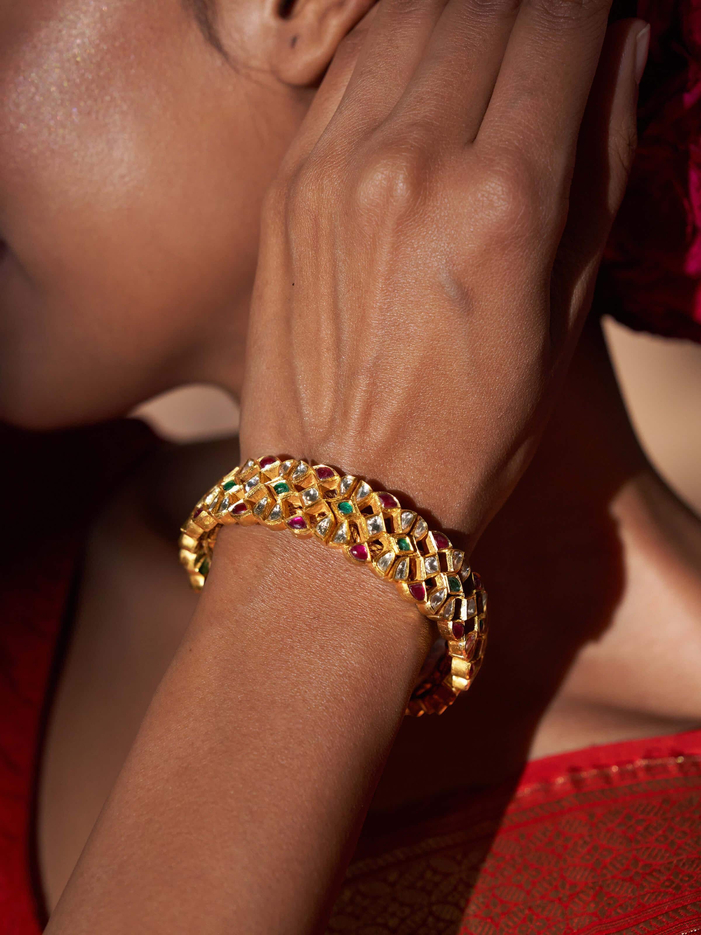 Detailed shot of Jadau 18 karat gold bracelet with a focus on its intricate artistry