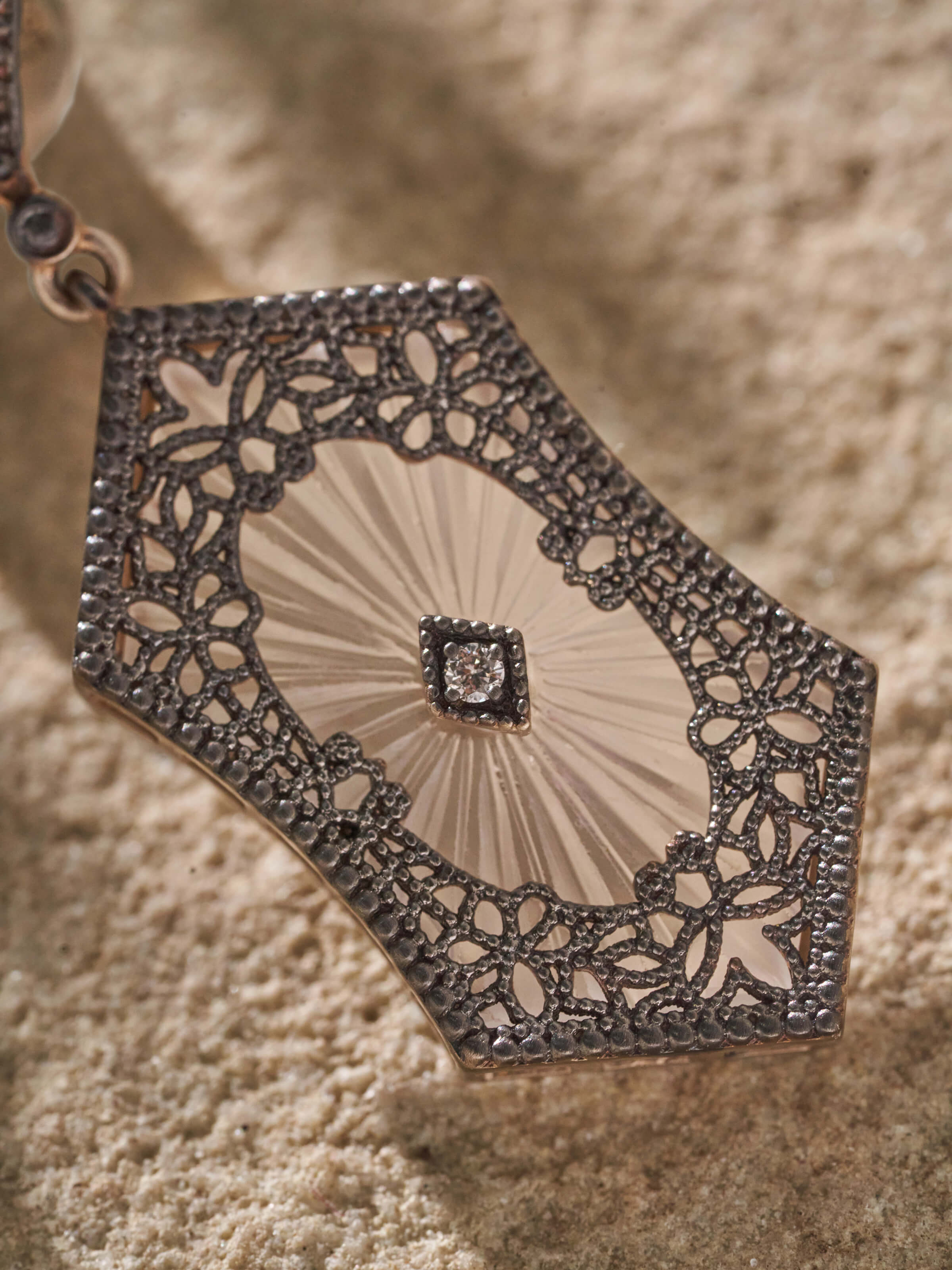 Close-up of Lapidary 14 karat gold drop earrings highlighting fine gold detailing and luxurious finish