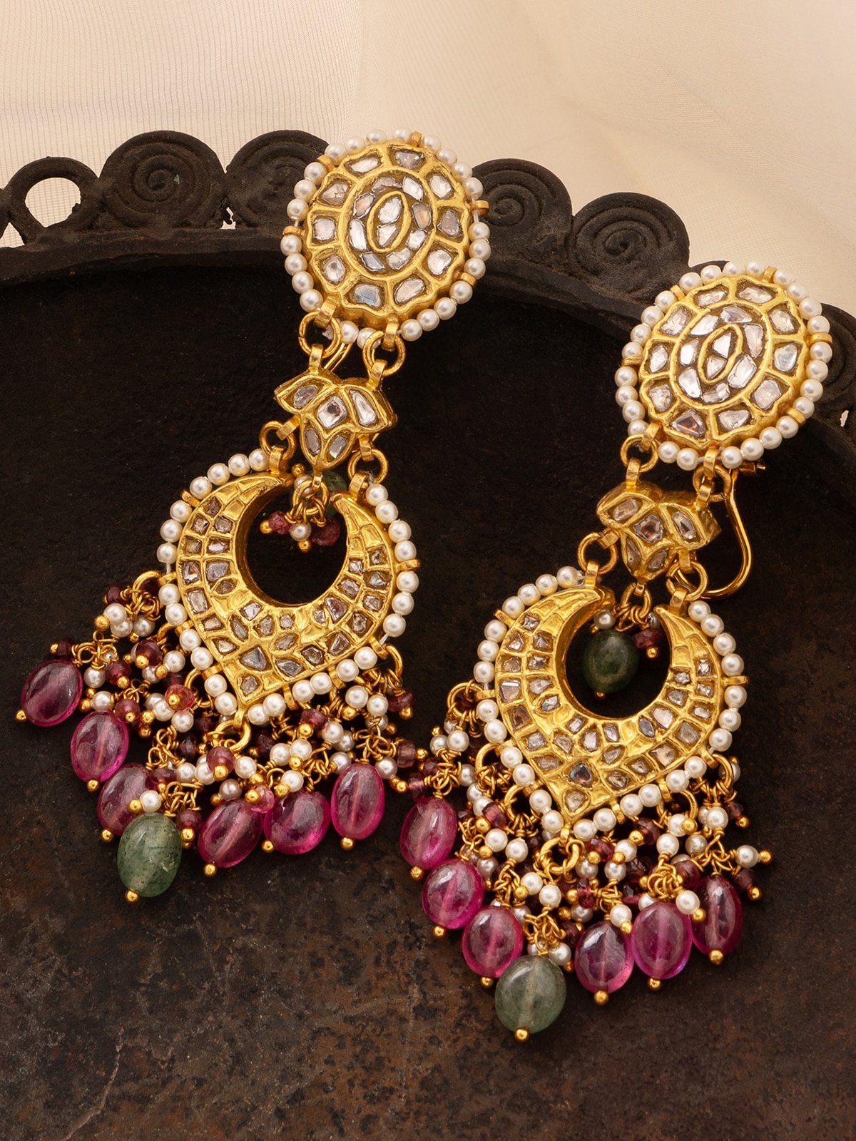 Side view of Thappa 22 karat gold drop earrings showcasing detailed craftsmanship and luxurious design