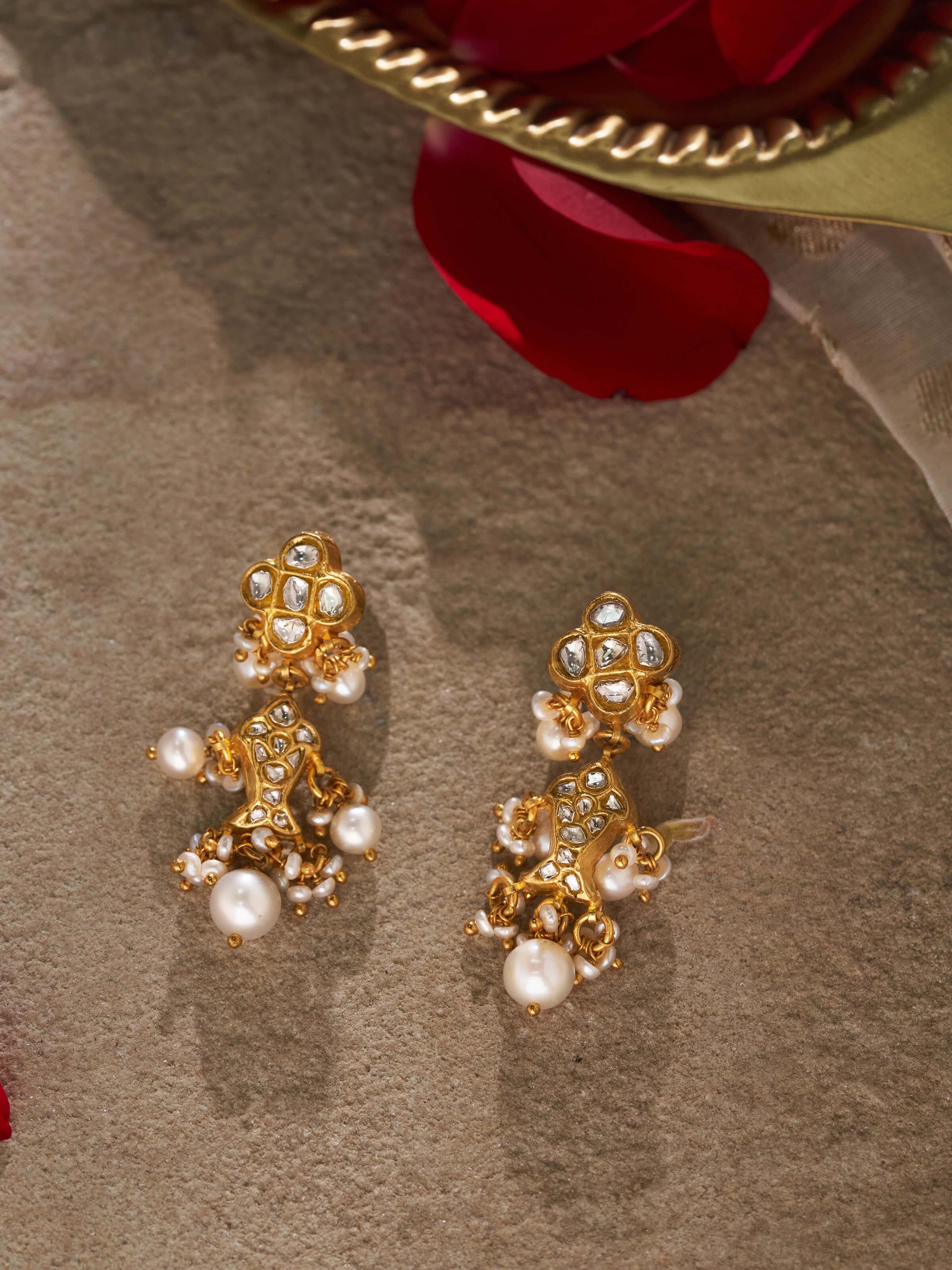 Side view of Thappa 22 Karat gold drop earrings highlighting their intricate design.