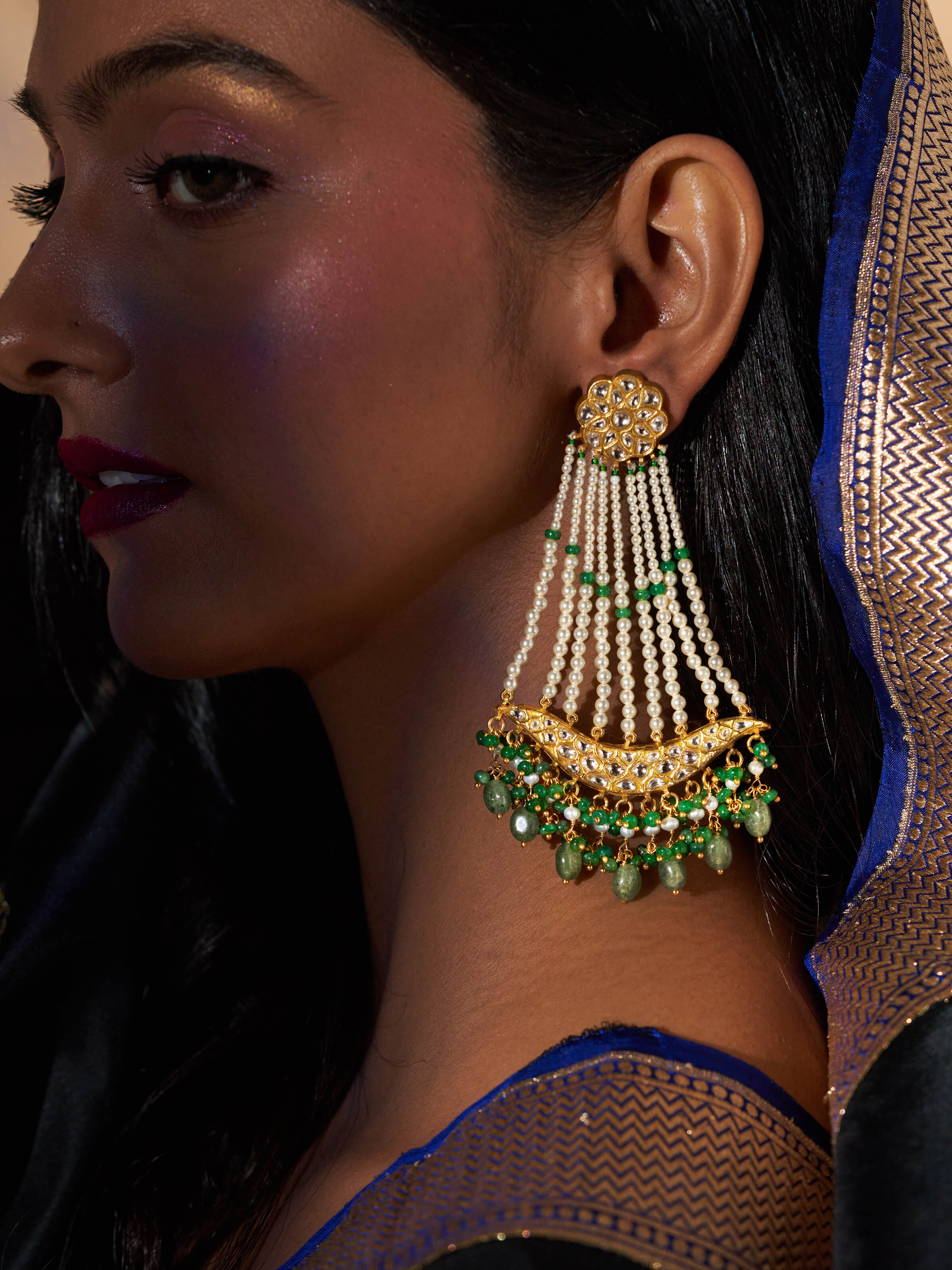 Lifestyle view of gold drop earrings paired with traditional outfit for elegant look