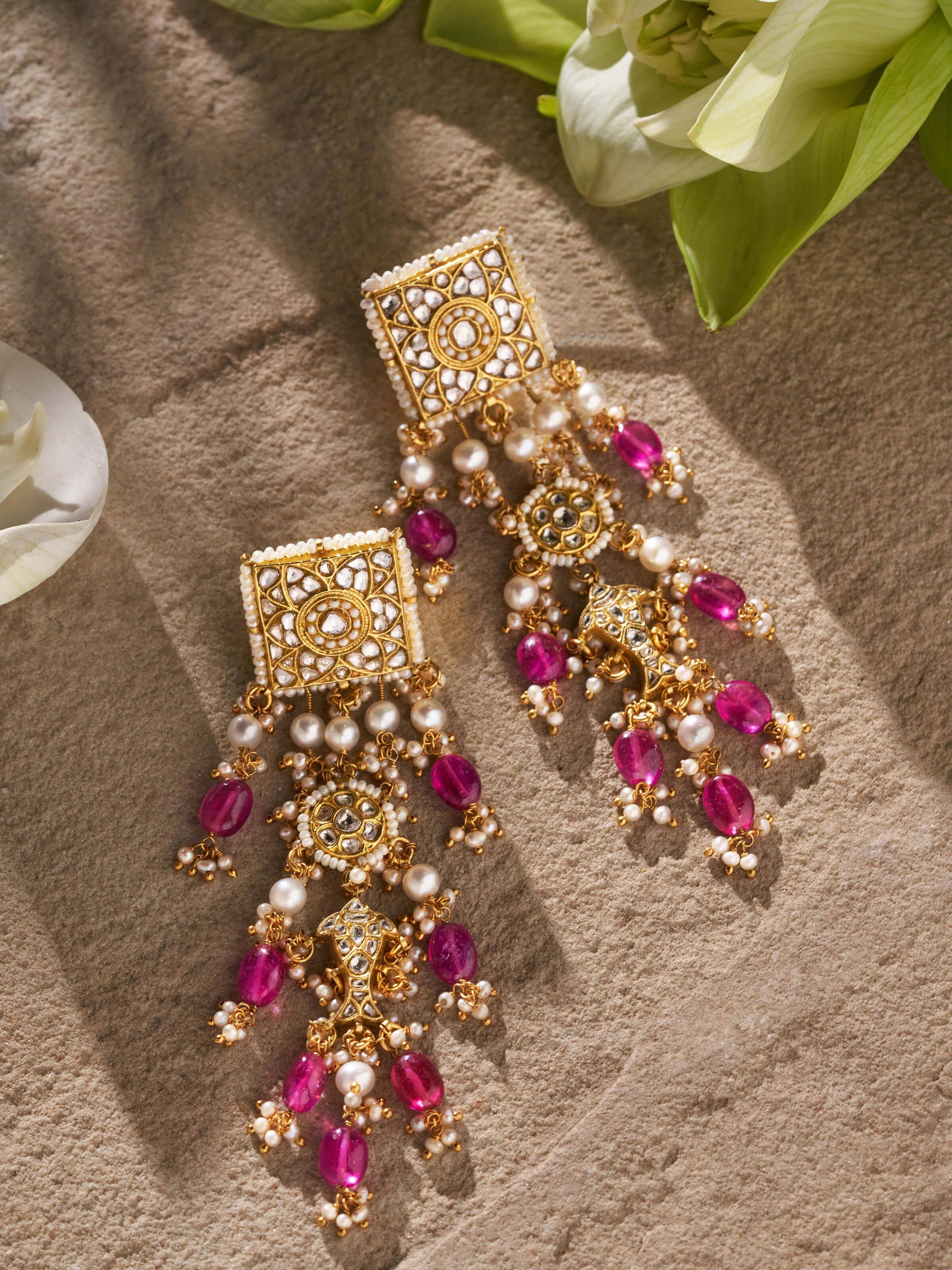 Side view of Thappa 22 karat gold drop earrings emphasizing the drop design and secure fastening.