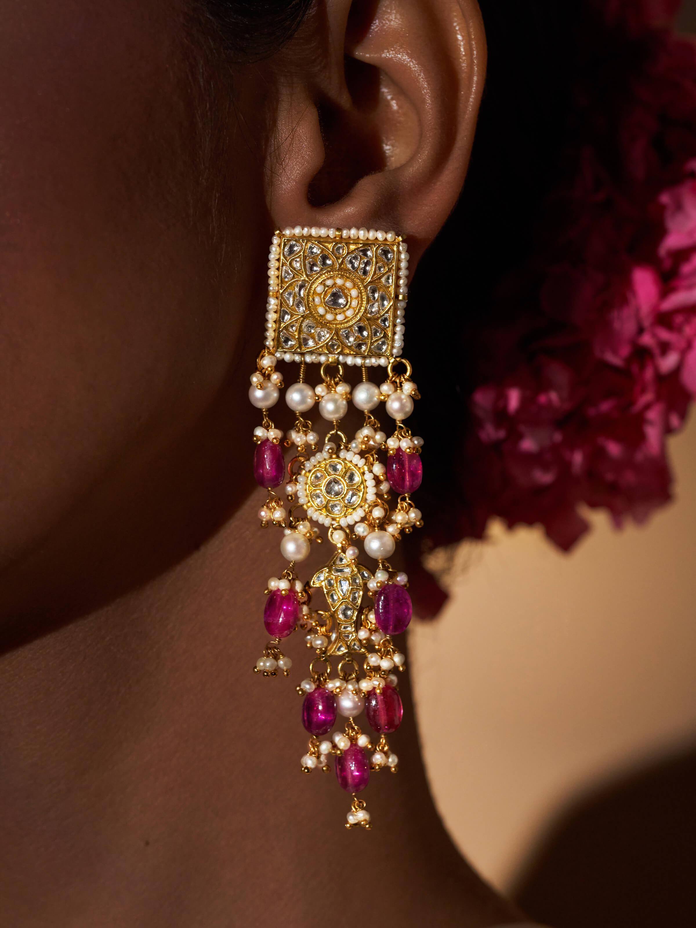 Detailed view of Thappa 22 karat gold drop earrings focusing on their fine gold detailing.