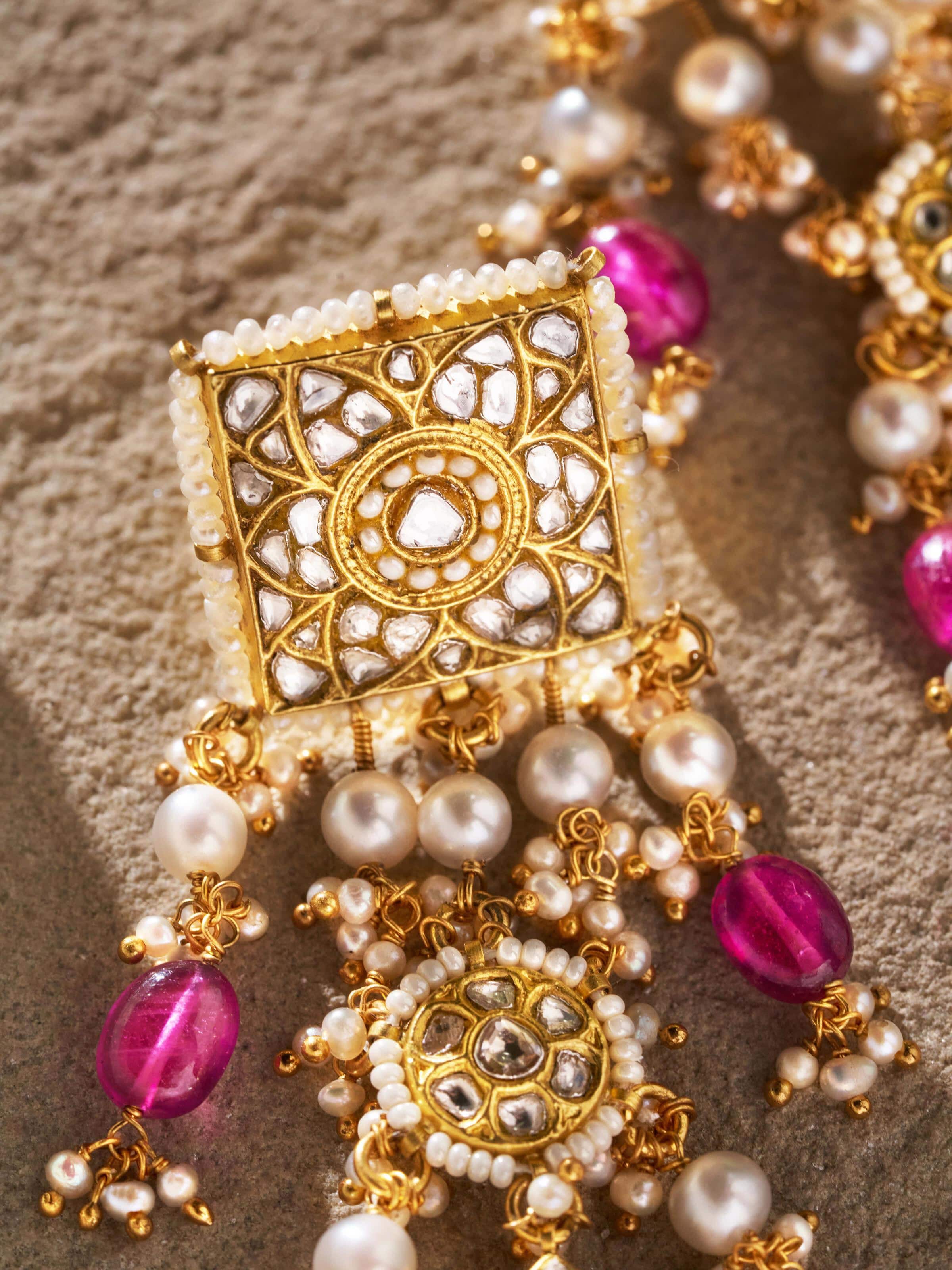 Back view of Thappa 22 karat gold drop earrings showing the secure clasp and elegant design.