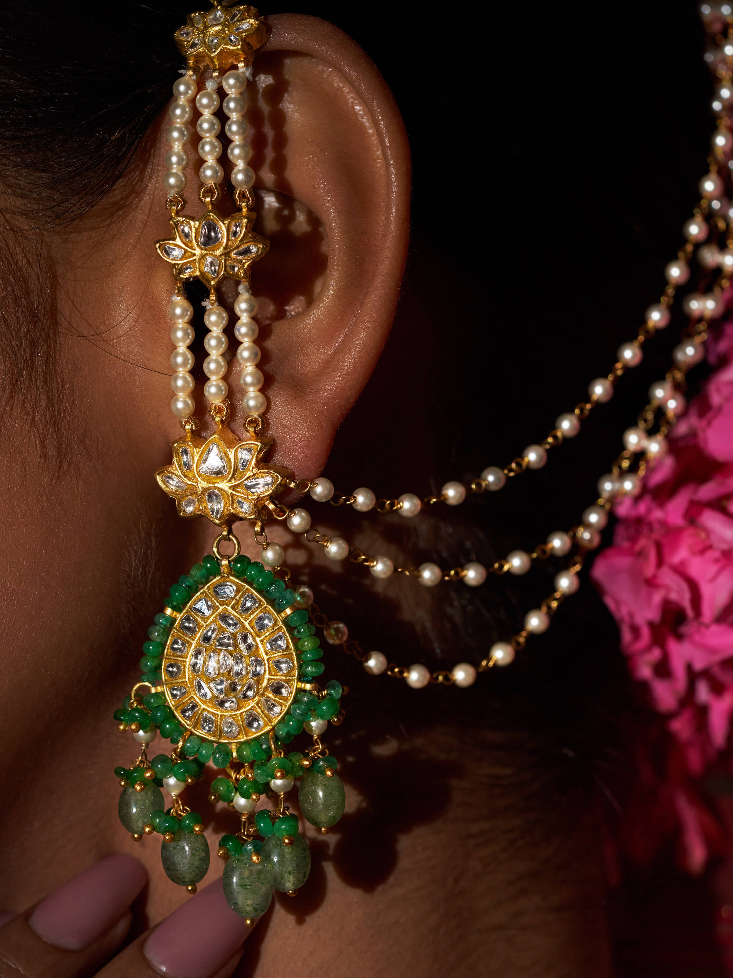 Close-up of the earrings focusing on the traditional matil pattern