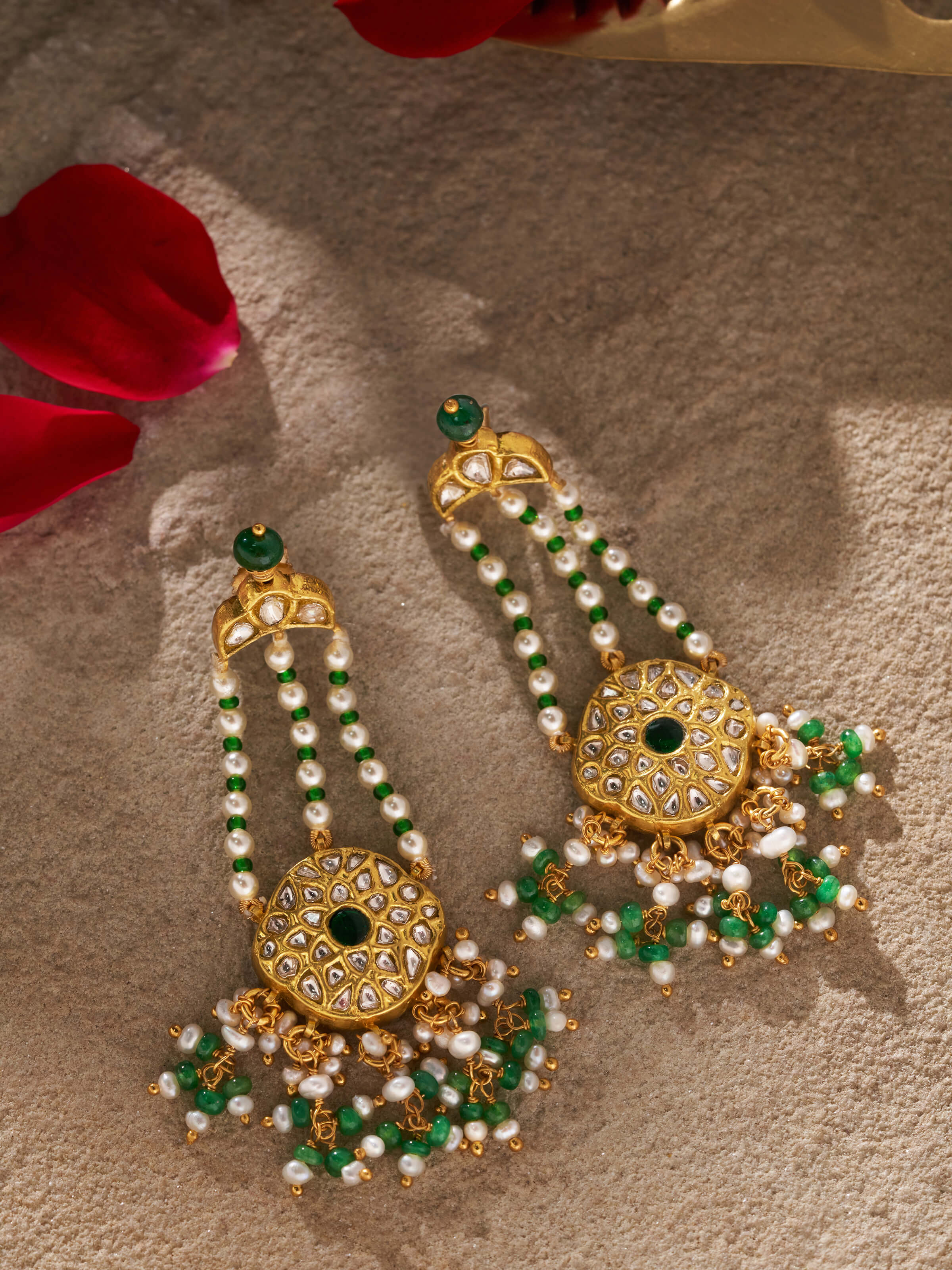 Front view highlighting the detailed design and rich gold finish of the earrings