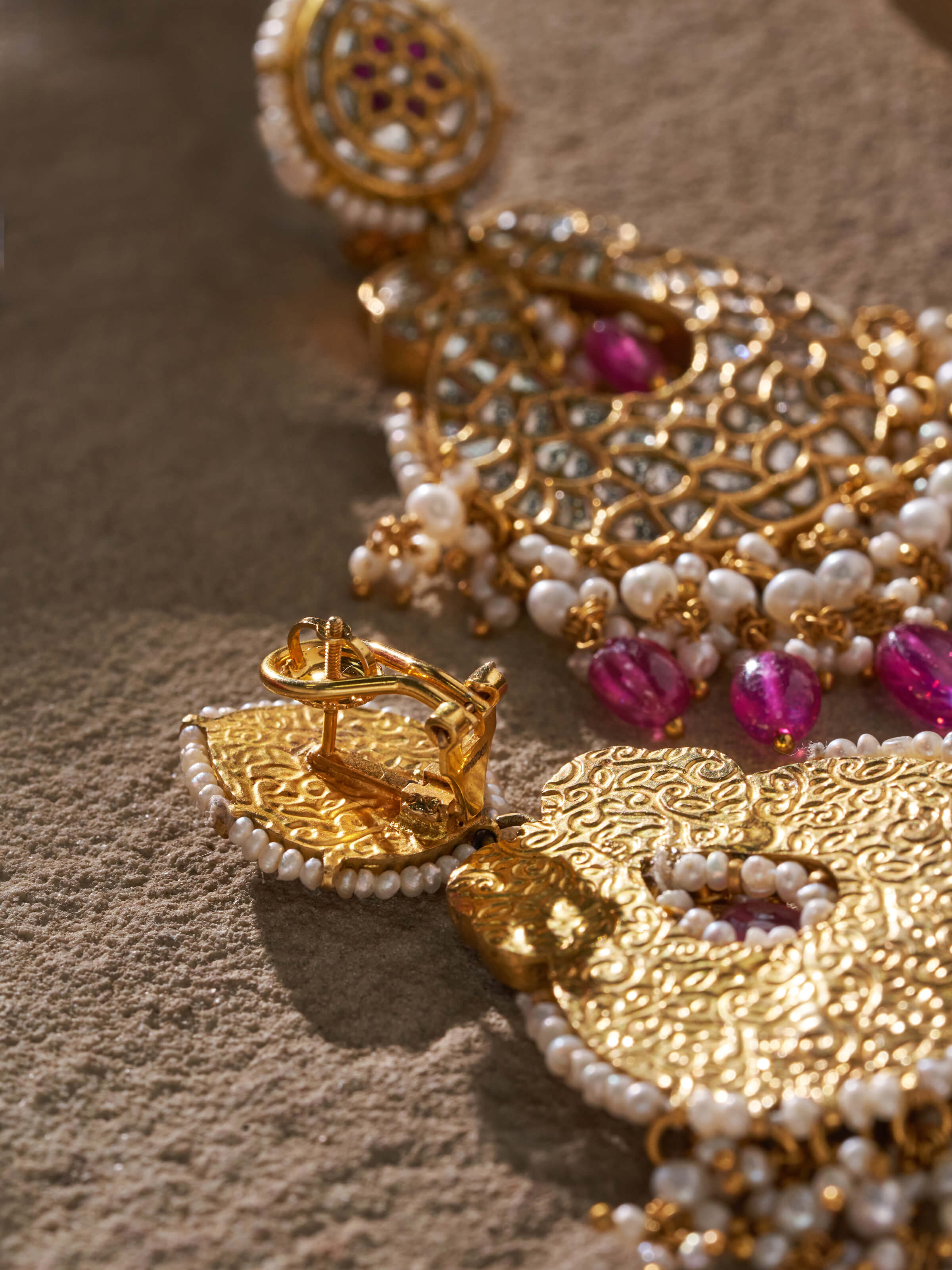 Front view of 22 karat gold drop earrings with focus on design and elegance