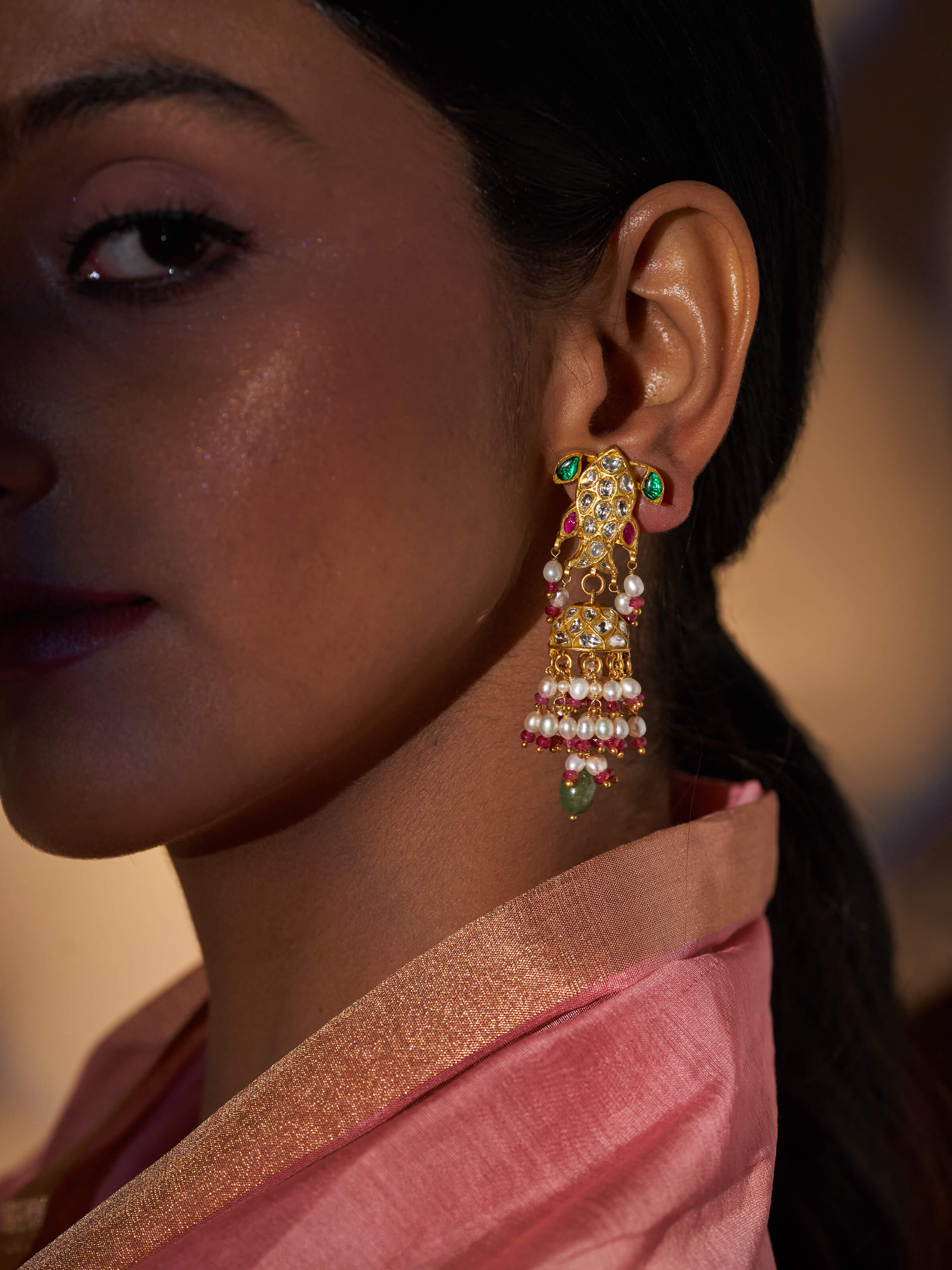 Close-up view of Thappa 22 karat gold drop earrings highlighting intricate goldwork.