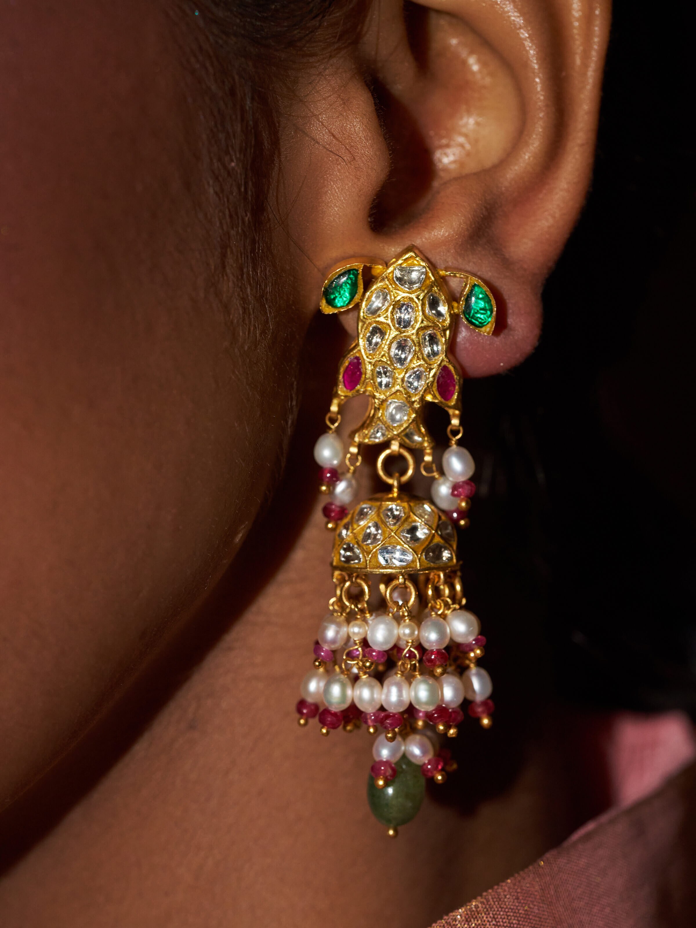 Angled view of Thappa 22 karat gold drop earrings showcasing their luxurious appearance.