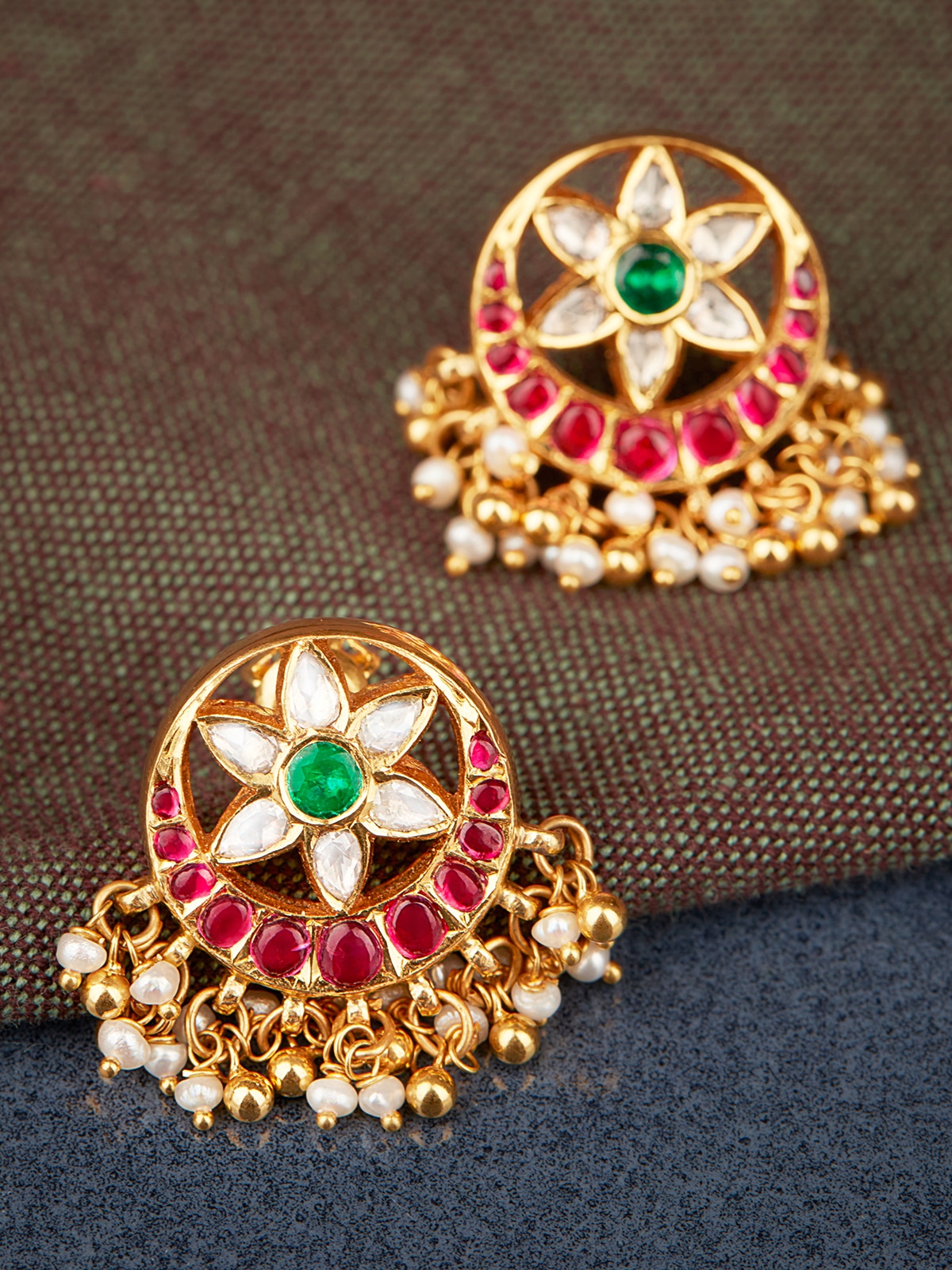 Kundala Velai 22 Karat Gold drop earrings displayed on a flat surface emphasizing their elegant design and craftsmanship.