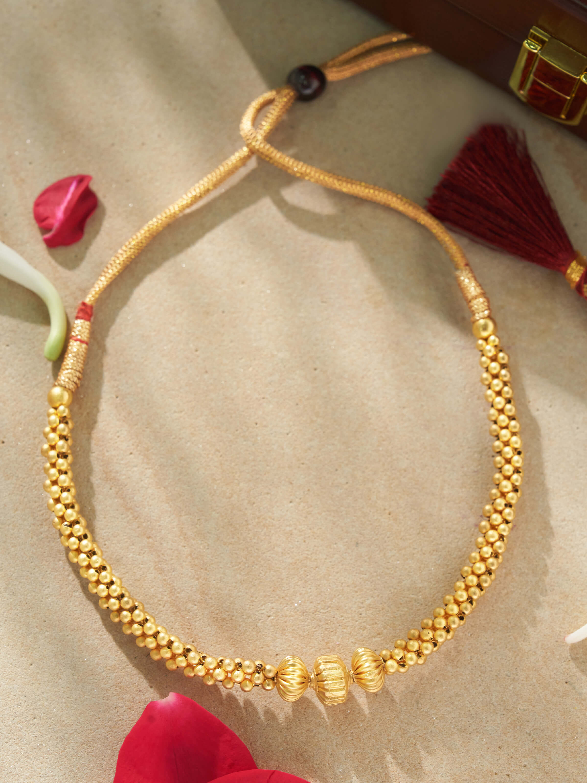Lifestyle shot of Thushi 22 Karat gold necklace styled with ethnic attire for festive elegance.