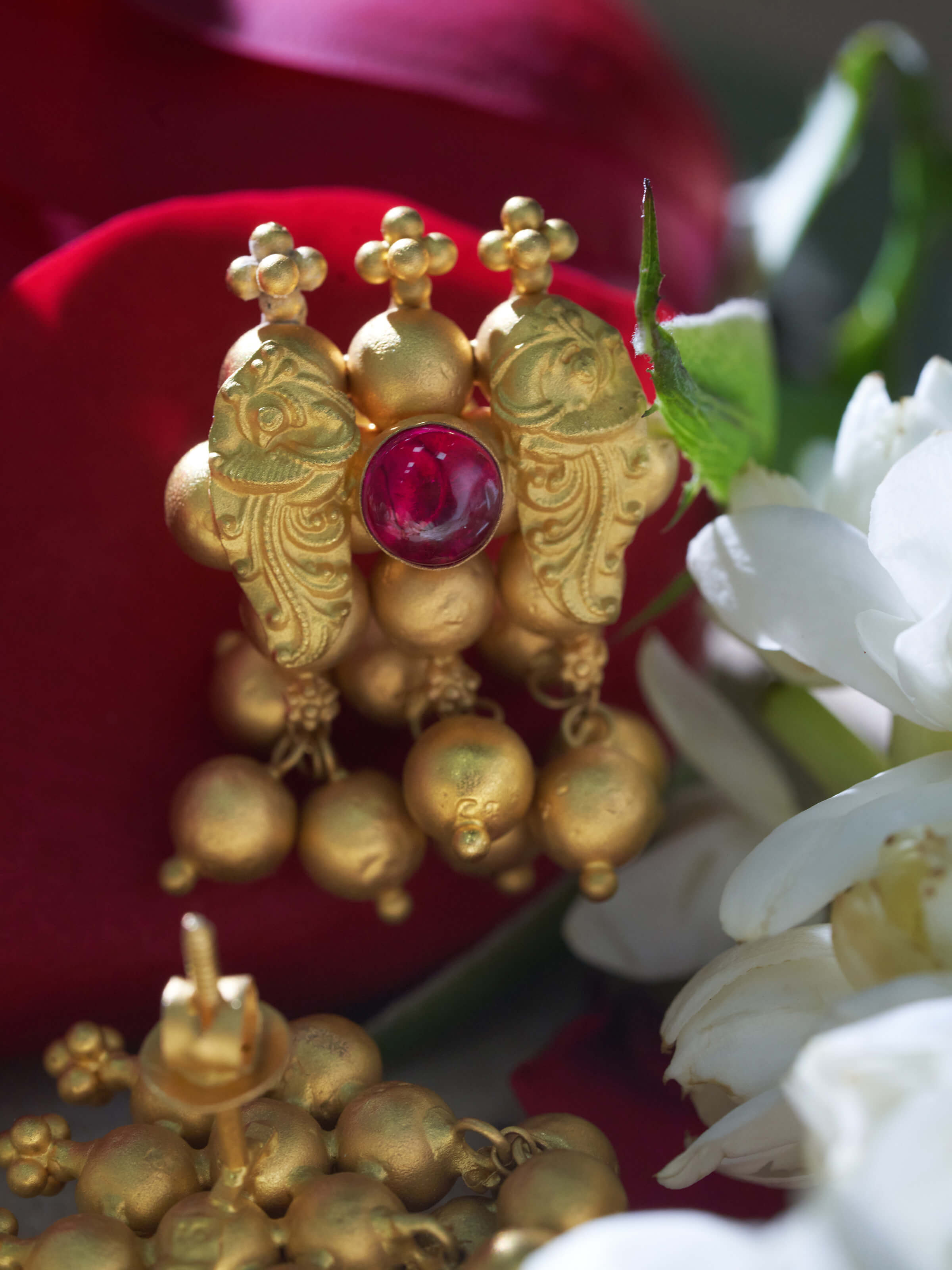 Close-up view of Thushi 22 karat gold drop earrings emphasizing fine craftsmanship