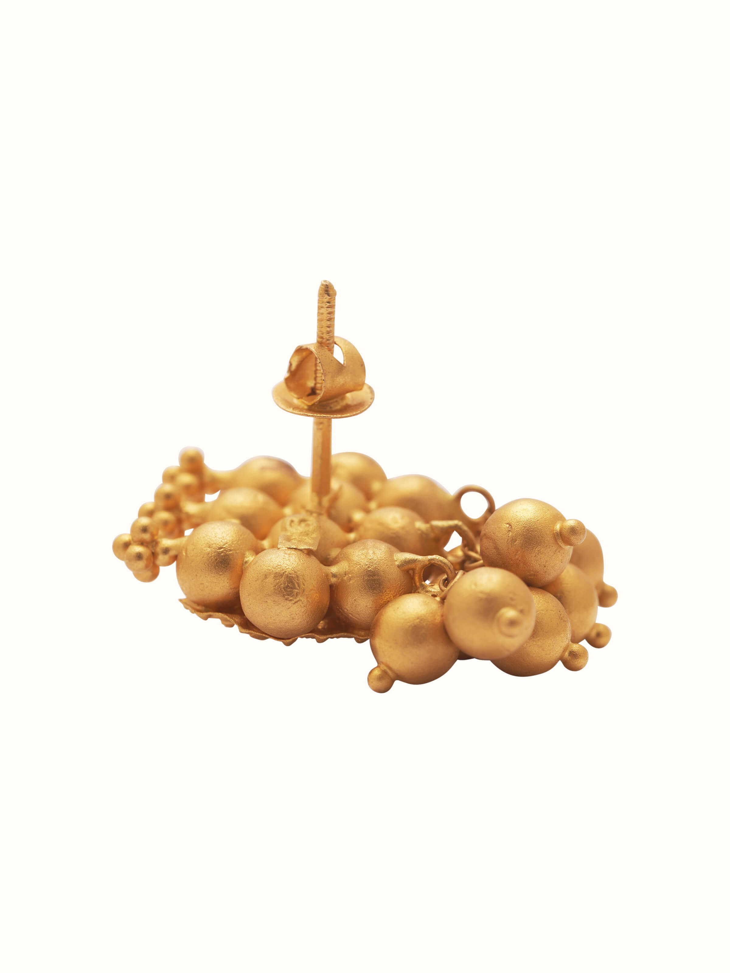 Angled view of Thushi 22 karat gold drop earrings showcasing their luxurious design