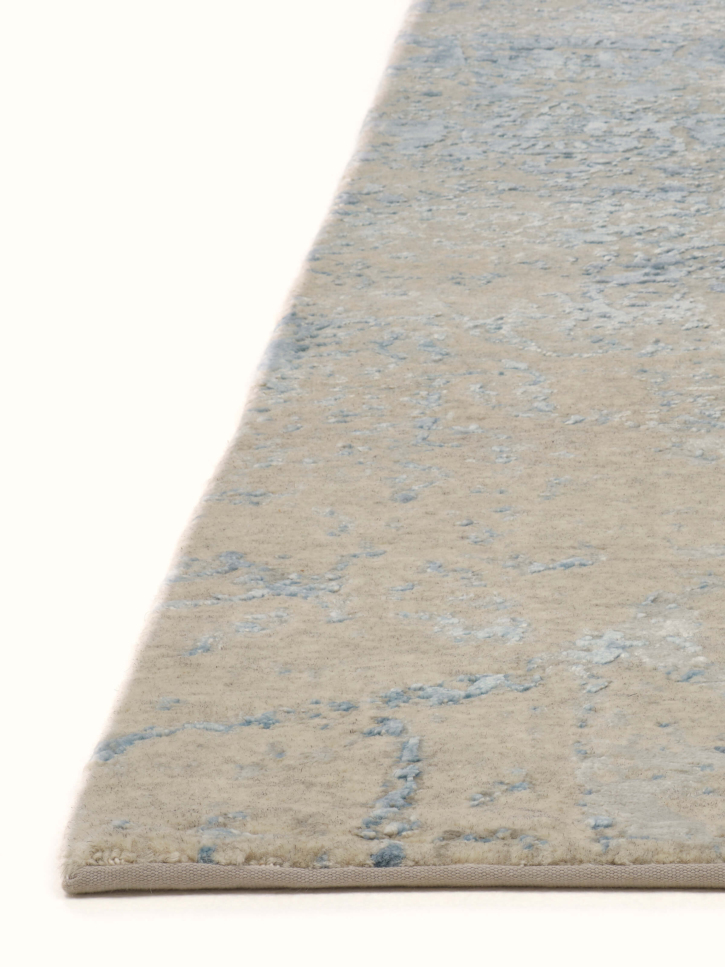 Overhead view of Modern Distressed Transitional Blue Bhadohi Wool & Viscose Hand-Knotted Rug, showcasing the full distressed pattern and color scheme.