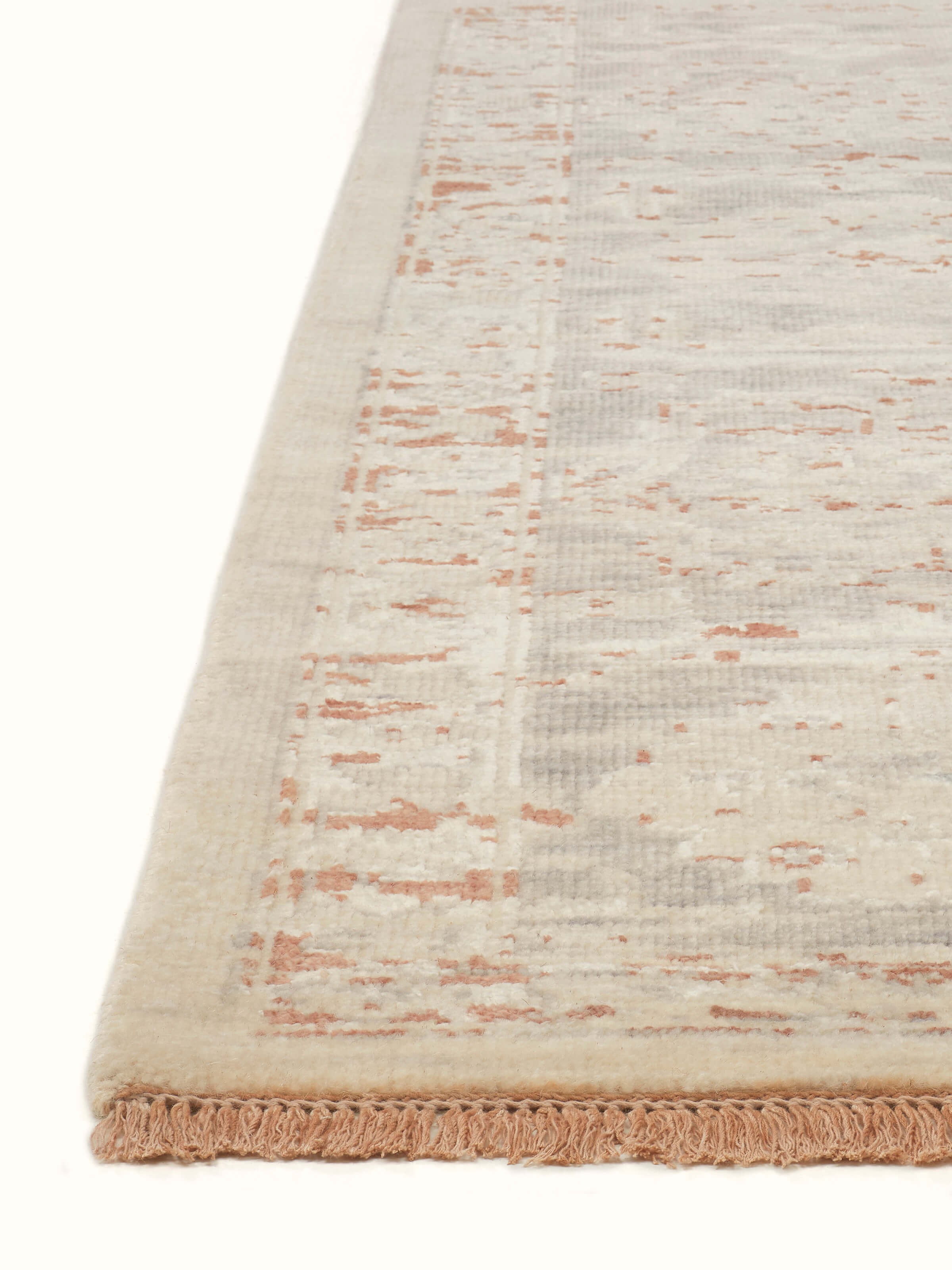 Angled view of Distressed transitional beige rust Bhadohi wool & silk hand-knotted rug showcasing the intricate design.