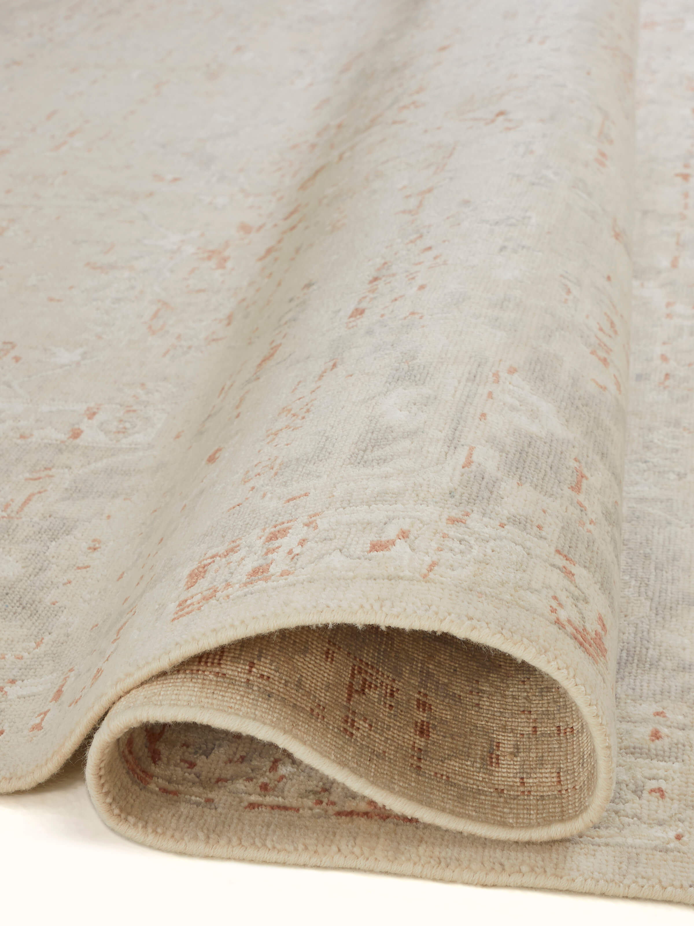 Close-up detail of Distressed transitional beige rust Bhadohi wool & silk hand-knotted rug highlighting the distressed effect.