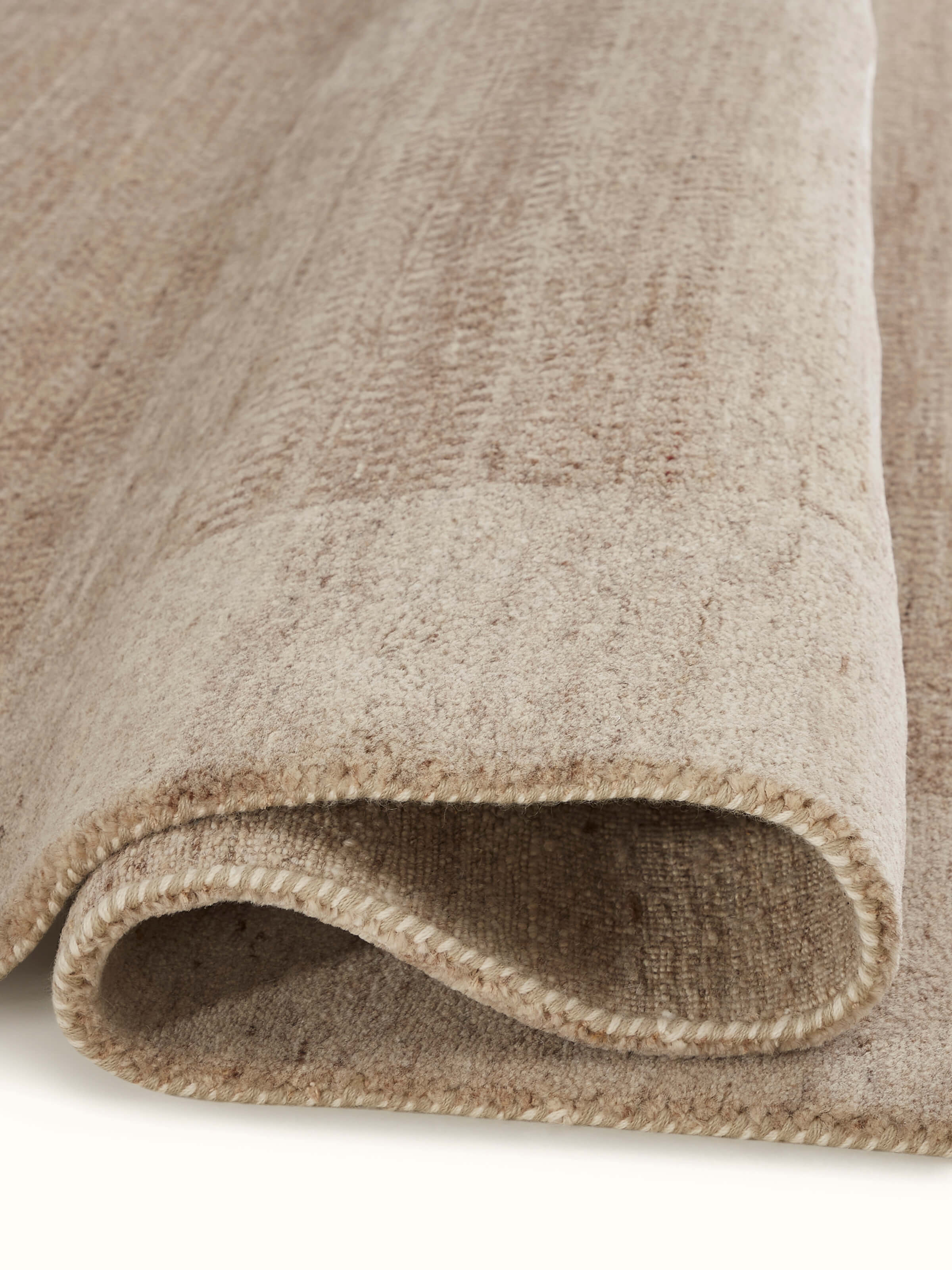 Back view of Traditional gabbeh beige brown Bhadohi wool hand-knotted rug showing the reverse side and craftsmanship