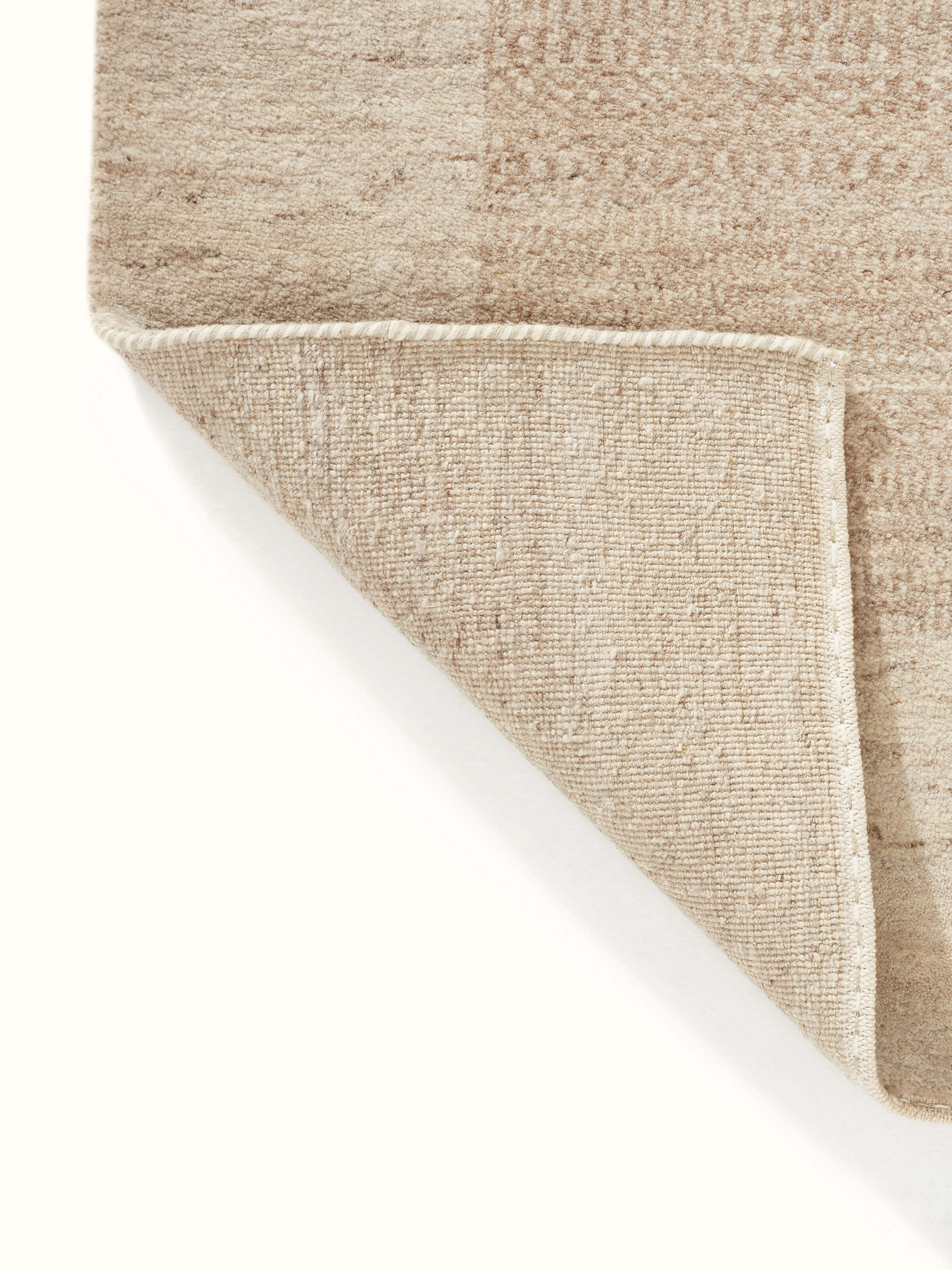 Close-up of Traditional gabbeh beige brown Bhadohi wool hand-knotted rug focusing on the intricate knotting and design