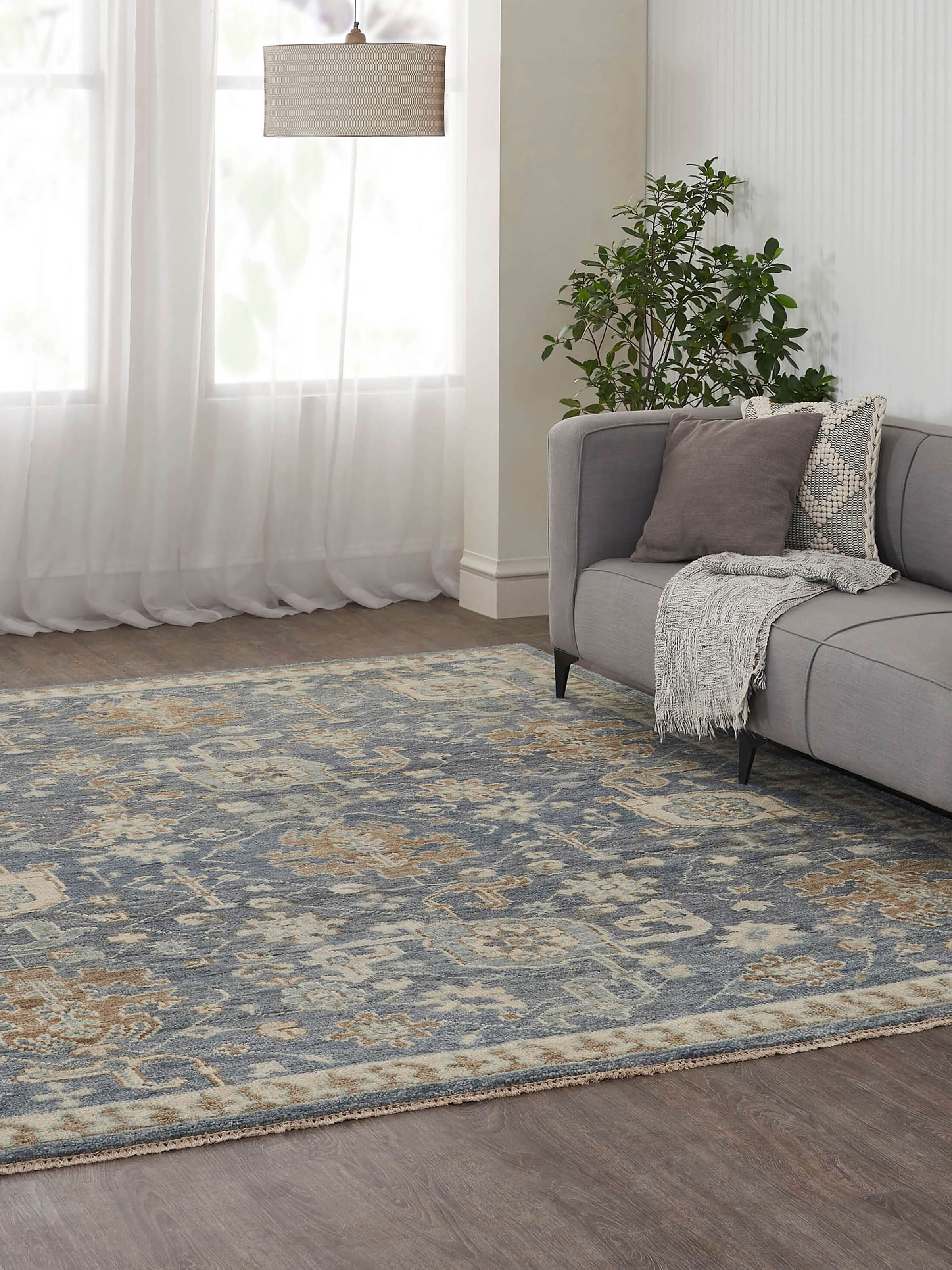 Lifestyle setting with traditional blue Oushak wool rug adding vintage charm to the interior.