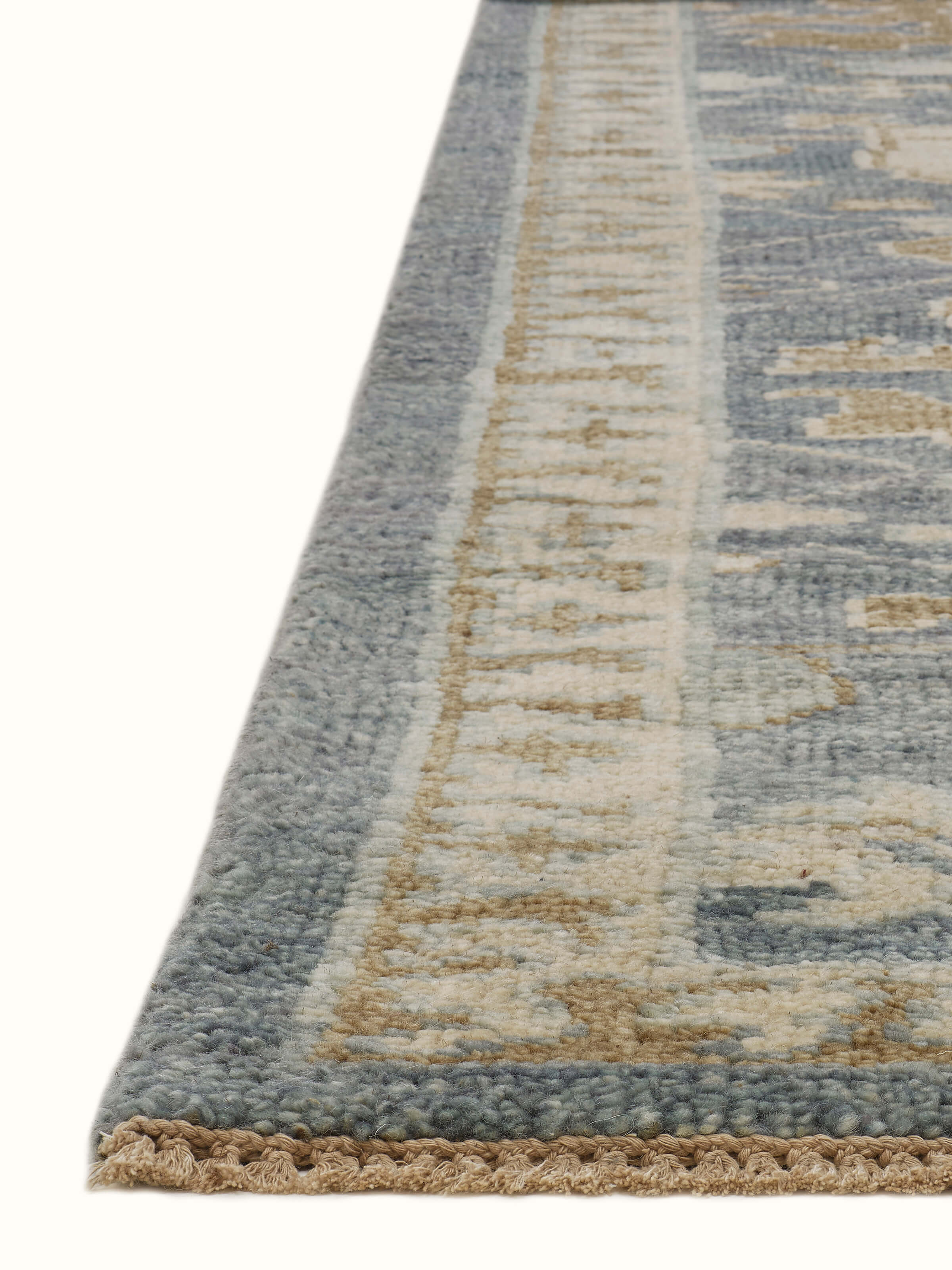 Close-up detail of Oushak traditional blue Bhadohi wool hand-knotted rug kharad emphasizing the craftsmanship and colors.