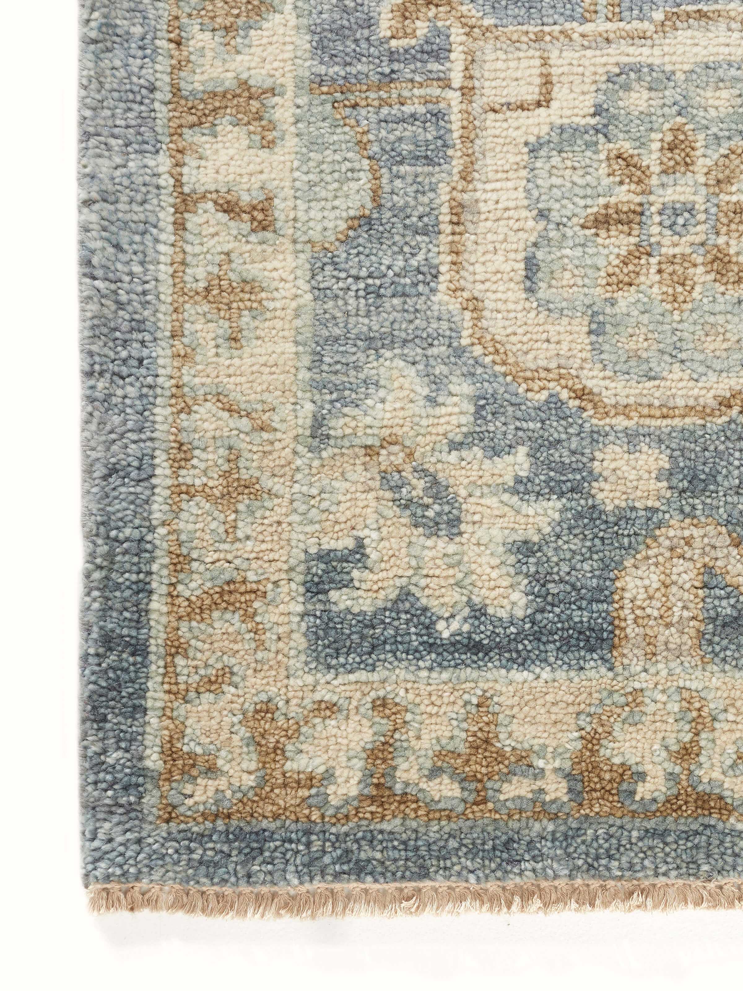 Back view of Oushak traditional blue Bhadohi wool hand-knotted rug kharad highlighting the rug’s full design and texture.
