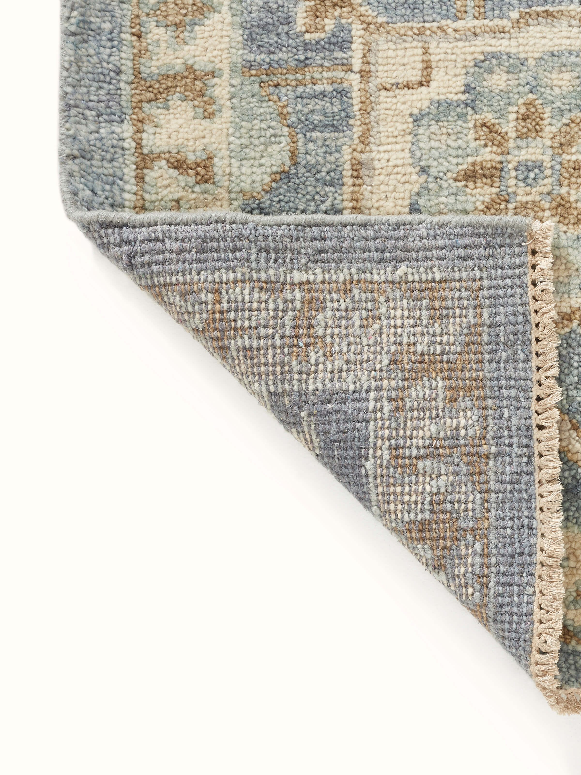 Detailed view of Oushak traditional blue Bhadohi wool hand-knotted rug kharad showing the intricate knotting and design.