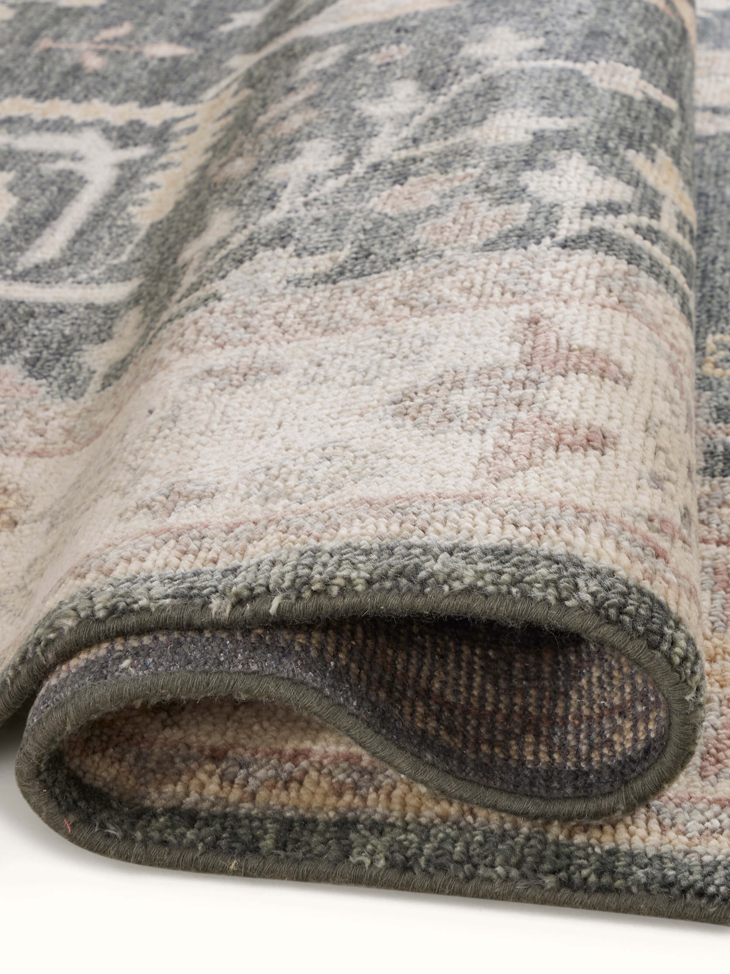 Oushak traditional grey Bhadohi wool hand-knotted rug kharad laid out to show its full pattern and size.