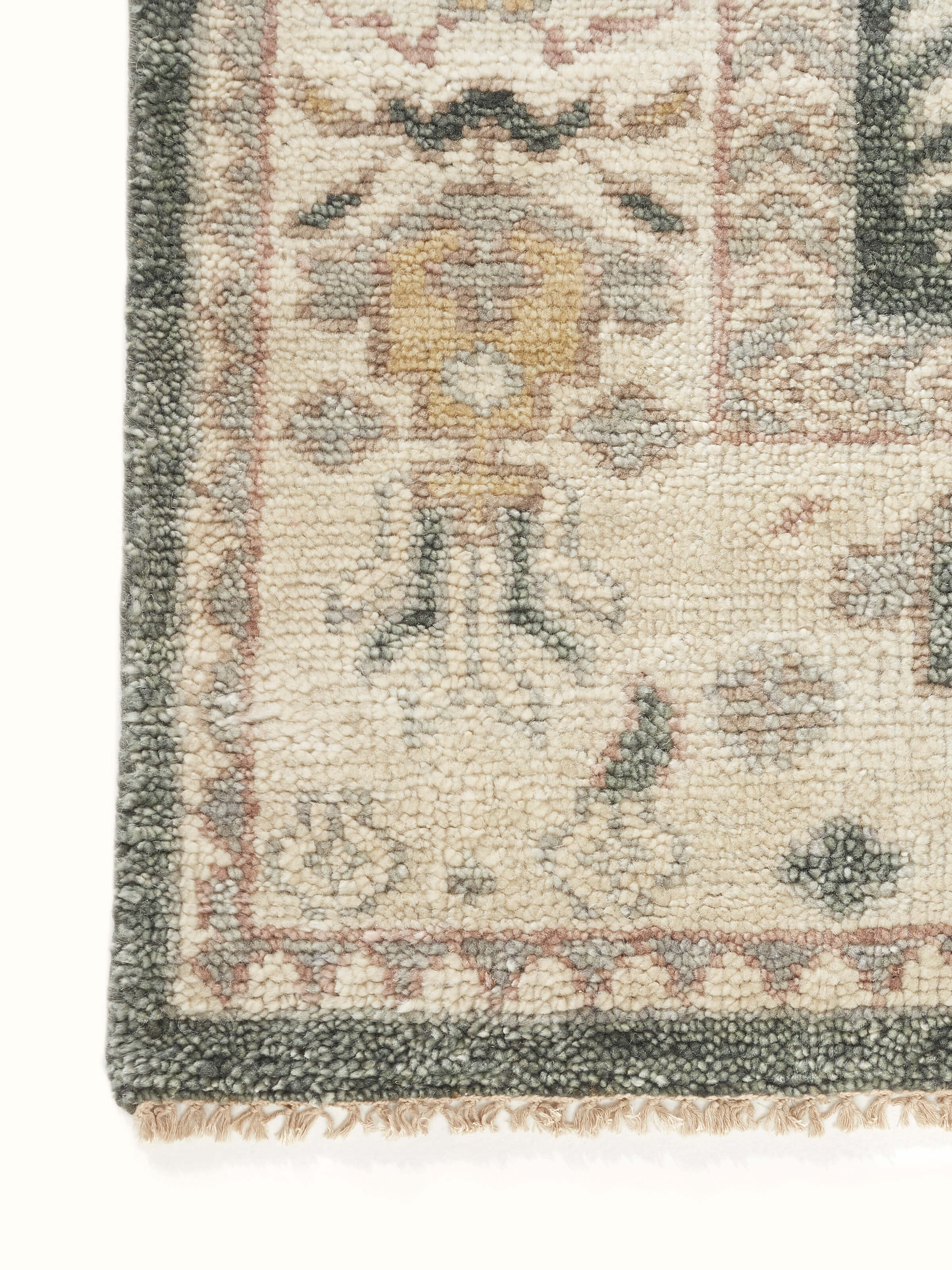Close-up of Oushak traditional grey Bhadohi wool hand-knotted rug kharad focusing on the rug's detailed wool fibers.