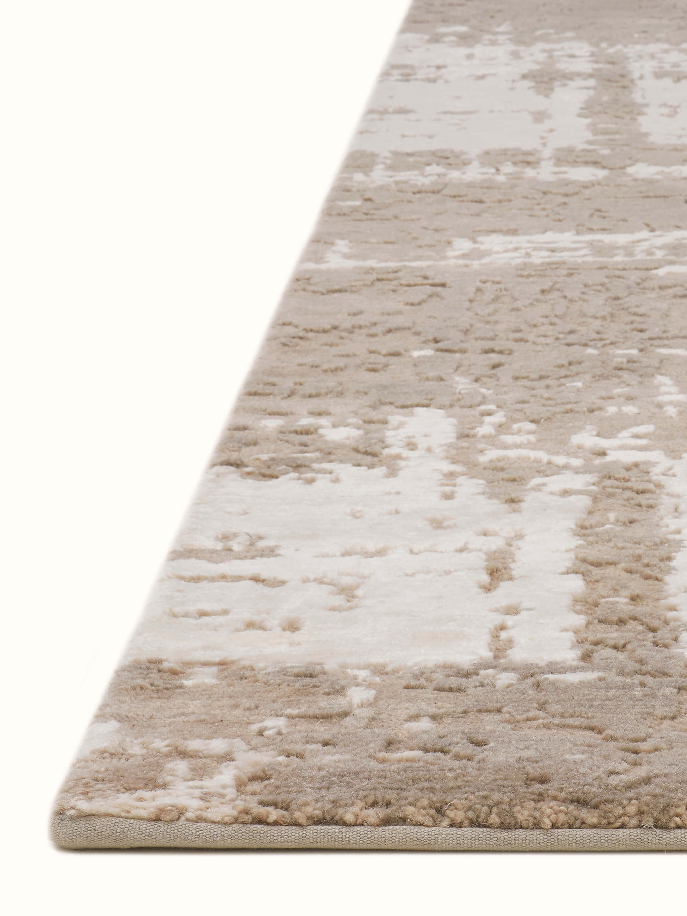 Angled view of Modern distress abstract grey silver Bhadohi wool & viscose hand-knotted rug emphasizing subtle color variations