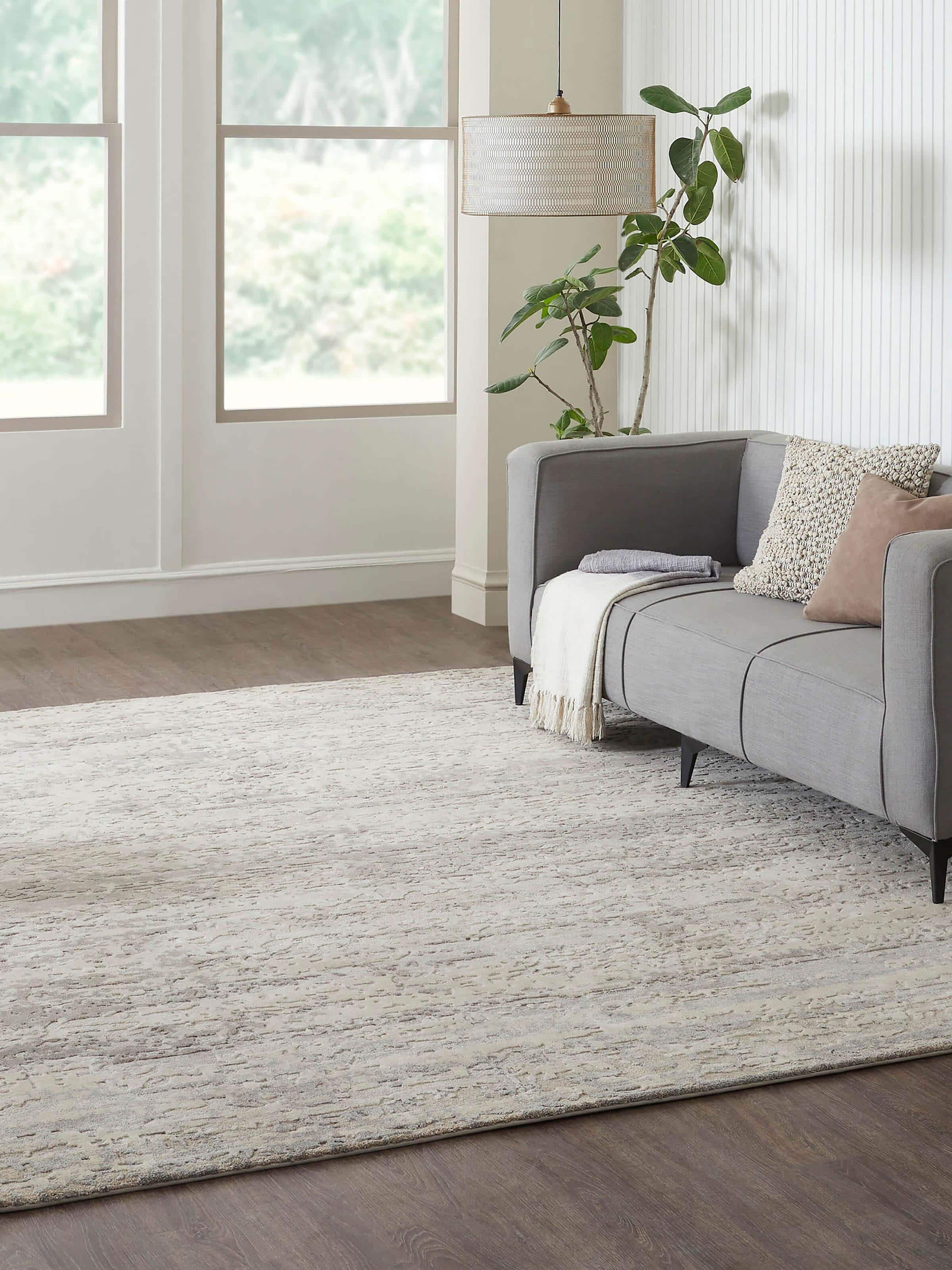 Lifestyle shot of modern beige and grey abstract hand-knotted rug in a Bhadohi wool and viscose blend.