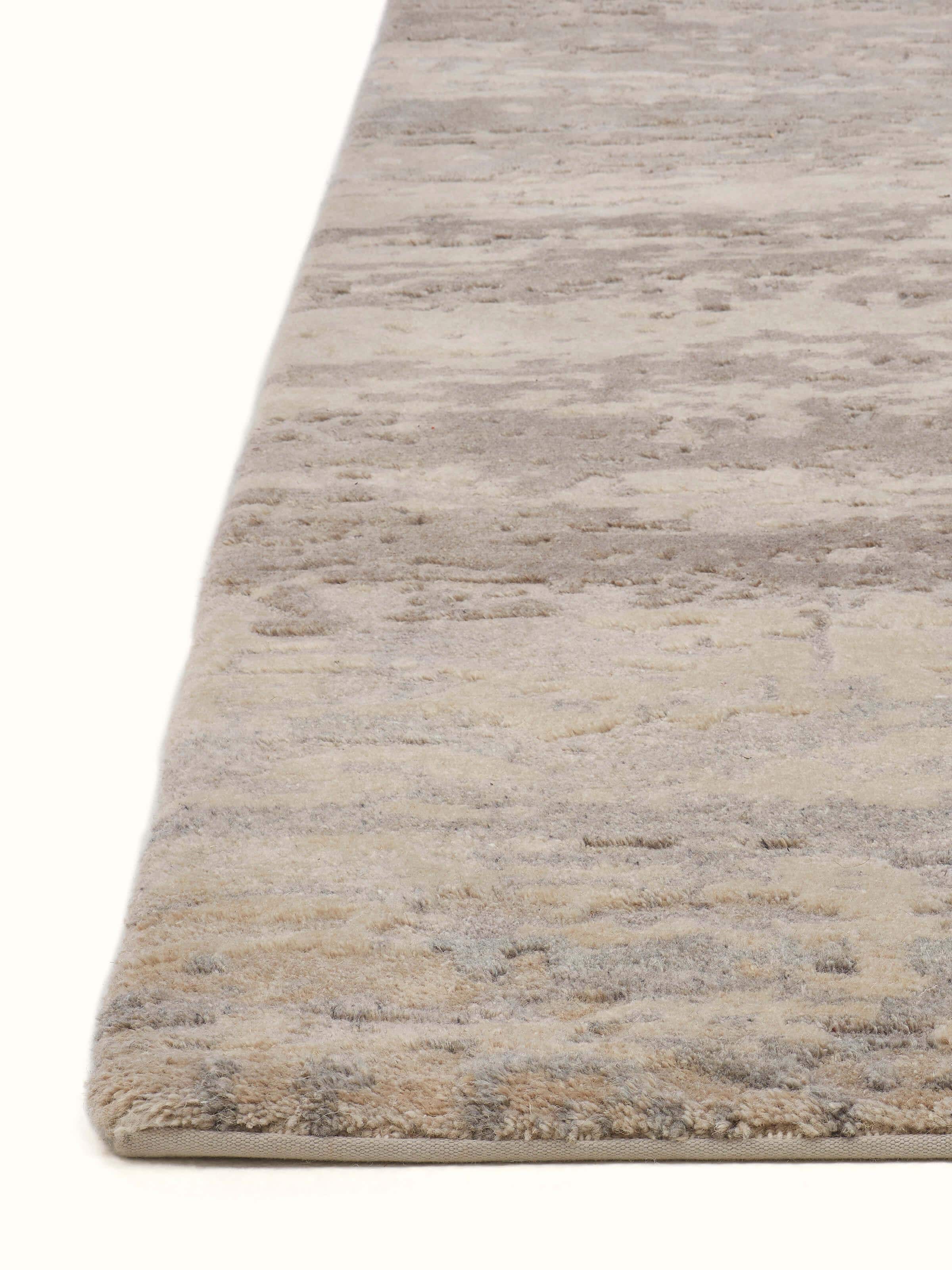 Angle view of Modern Distress Abstract Grey Bhadohi Wool & Viscose Hand-Knotted Rug highlighting color and pattern.