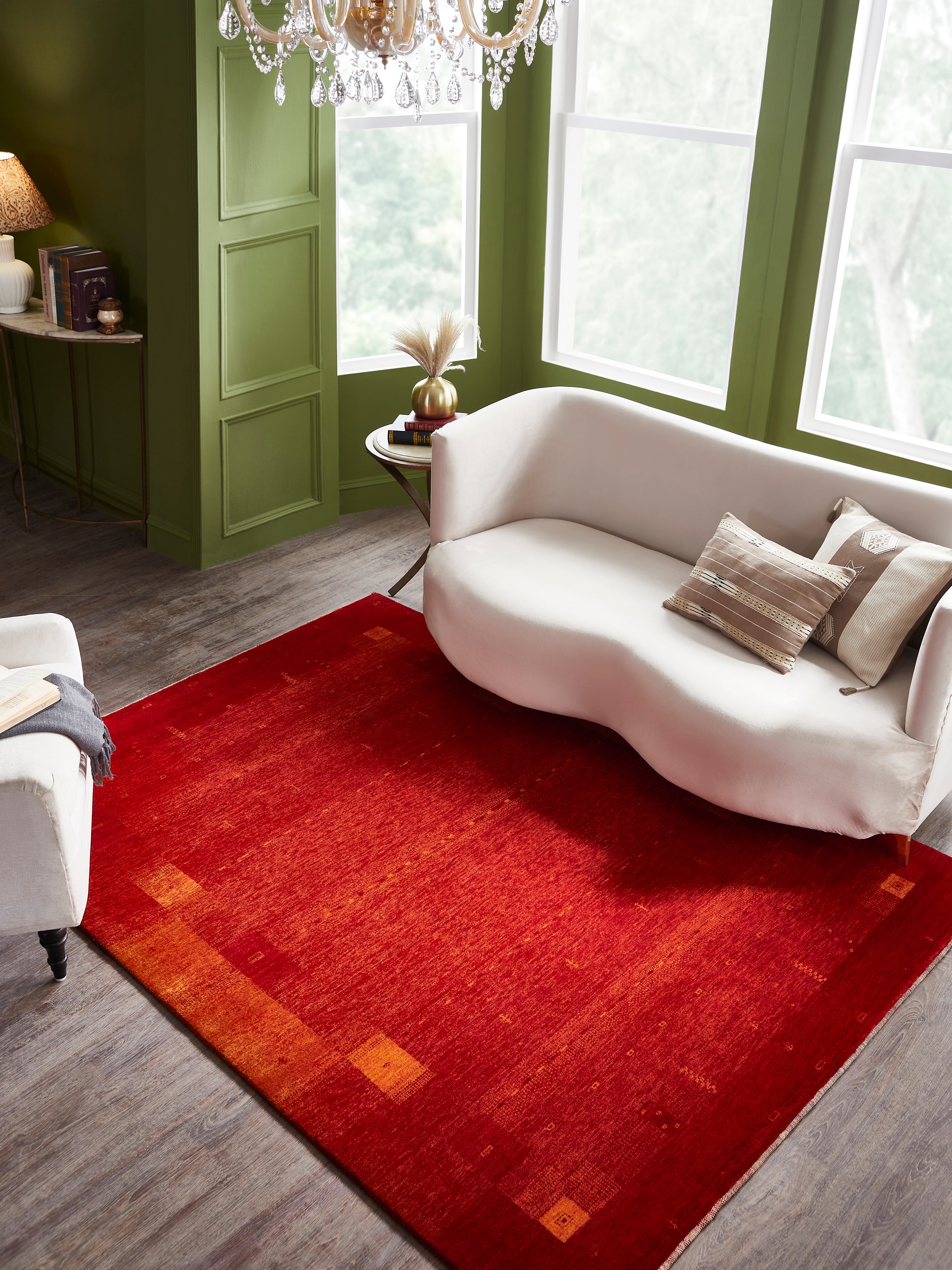 Lifestyle setting of Traditional Gabbeh Red Bhadohi Wool Hand-knotted Rug with tribal-inspired motifs and bold tones by Swadesh