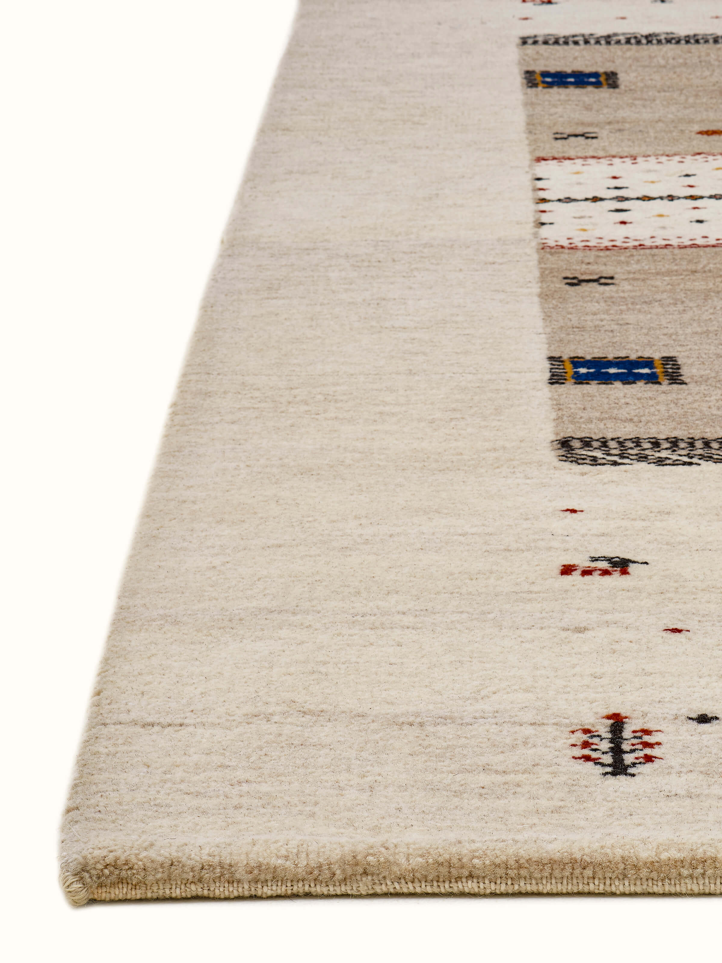 Traditional Gabbeh ivory beige Bhadohi wool hand-knotted rug with kharad pattern, angled view.