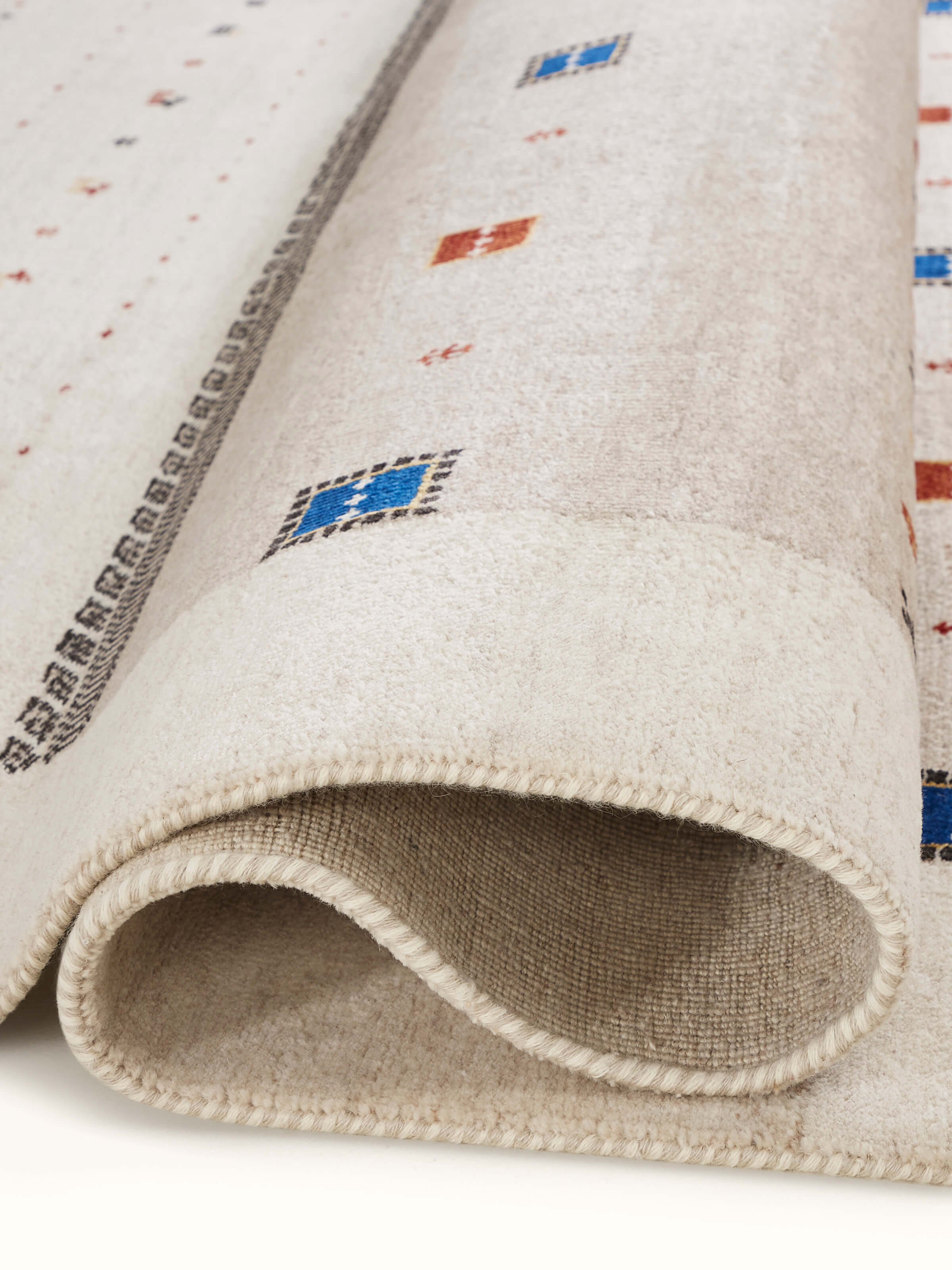 Traditional Gabbeh ivory beige Bhadohi wool hand-knotted rug with kharad pattern, detailed view.