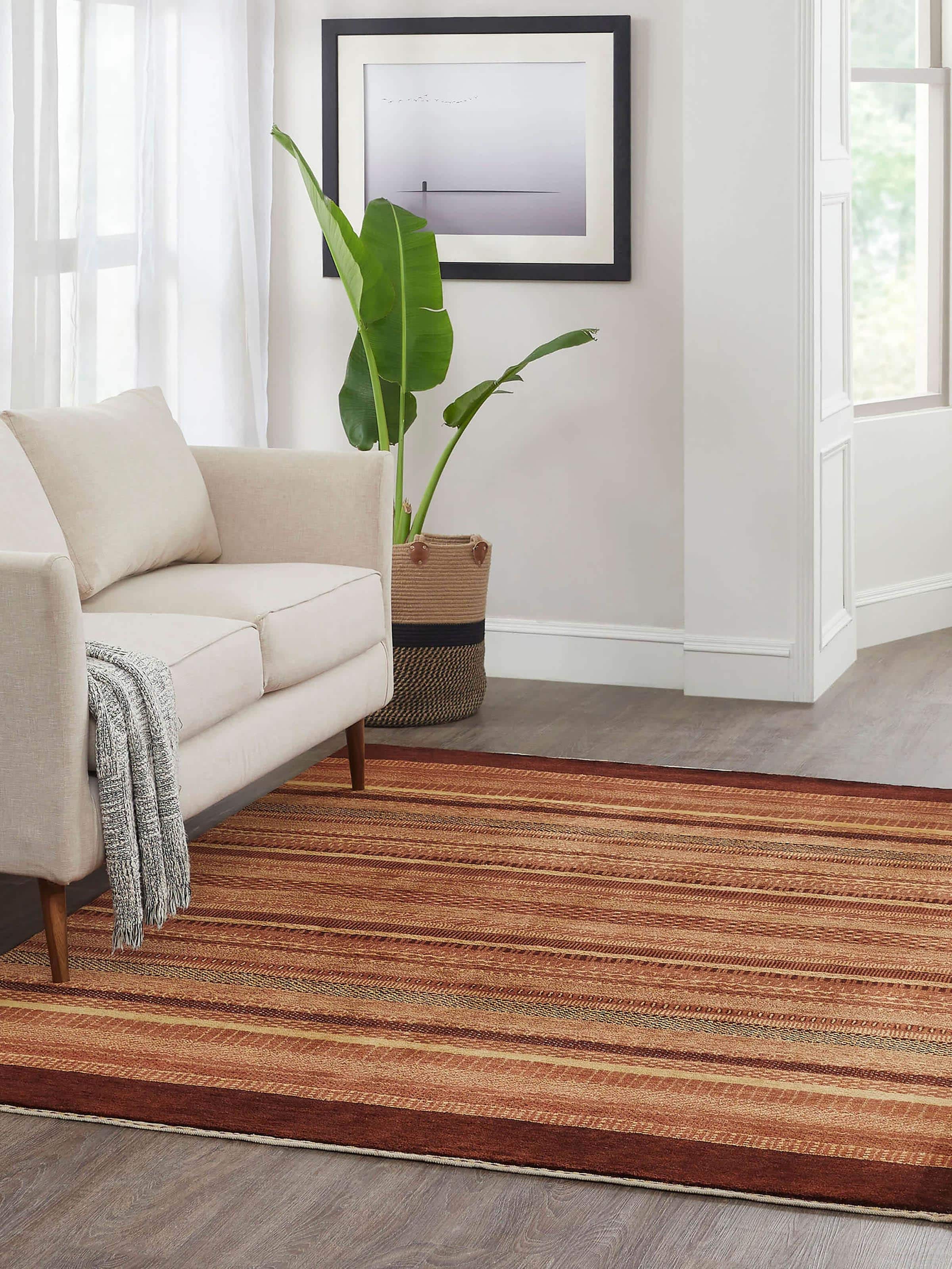 Lifestyle shot of rust-colored Gabbeh-style wool rug hand-knotted in Bhadohi craftsmanship.