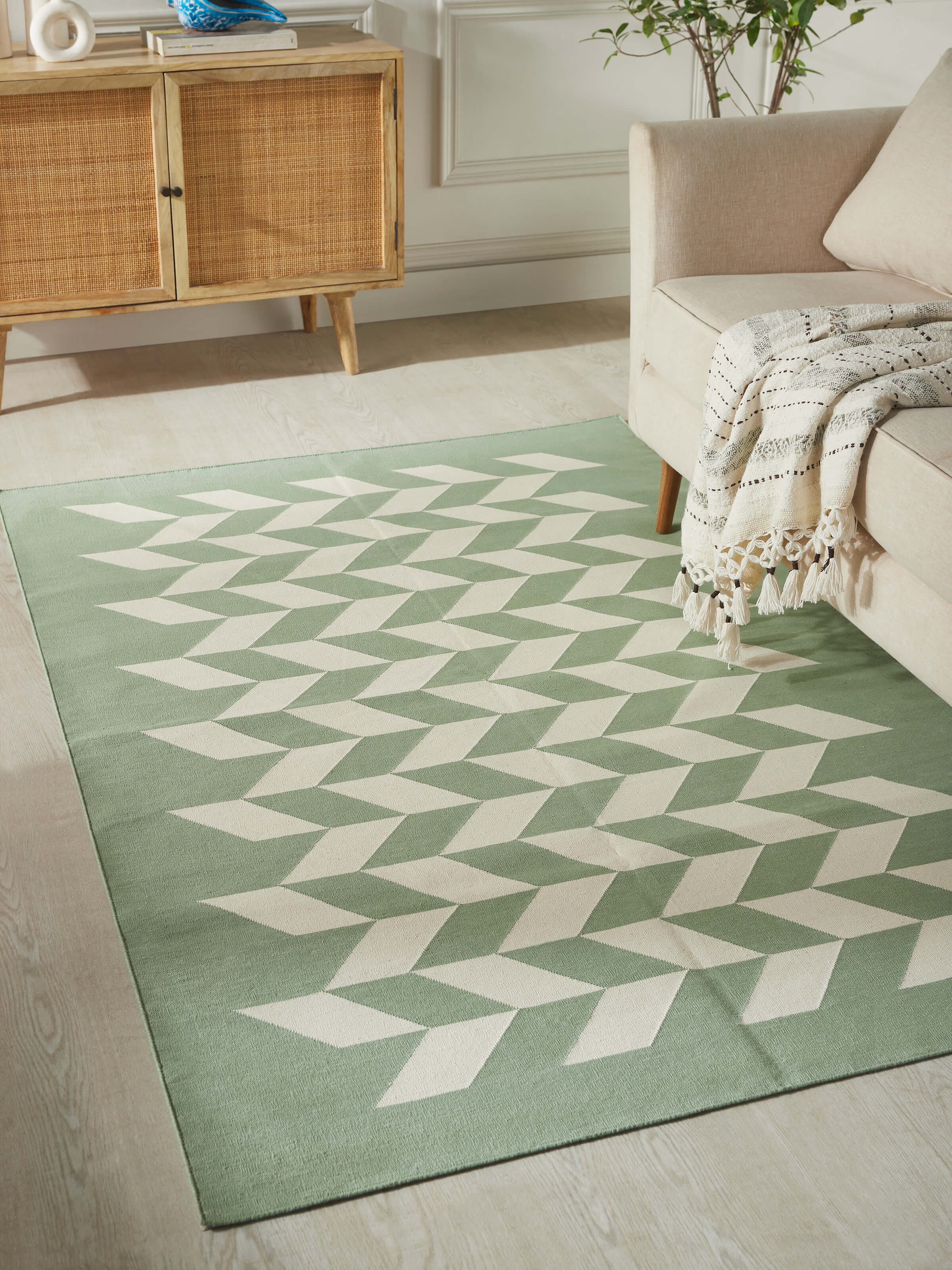 Detailed view of Modern geo chevron light green ivory lawan cotton panja dhurrie kharad highlighting the cotton texture and chevron design.