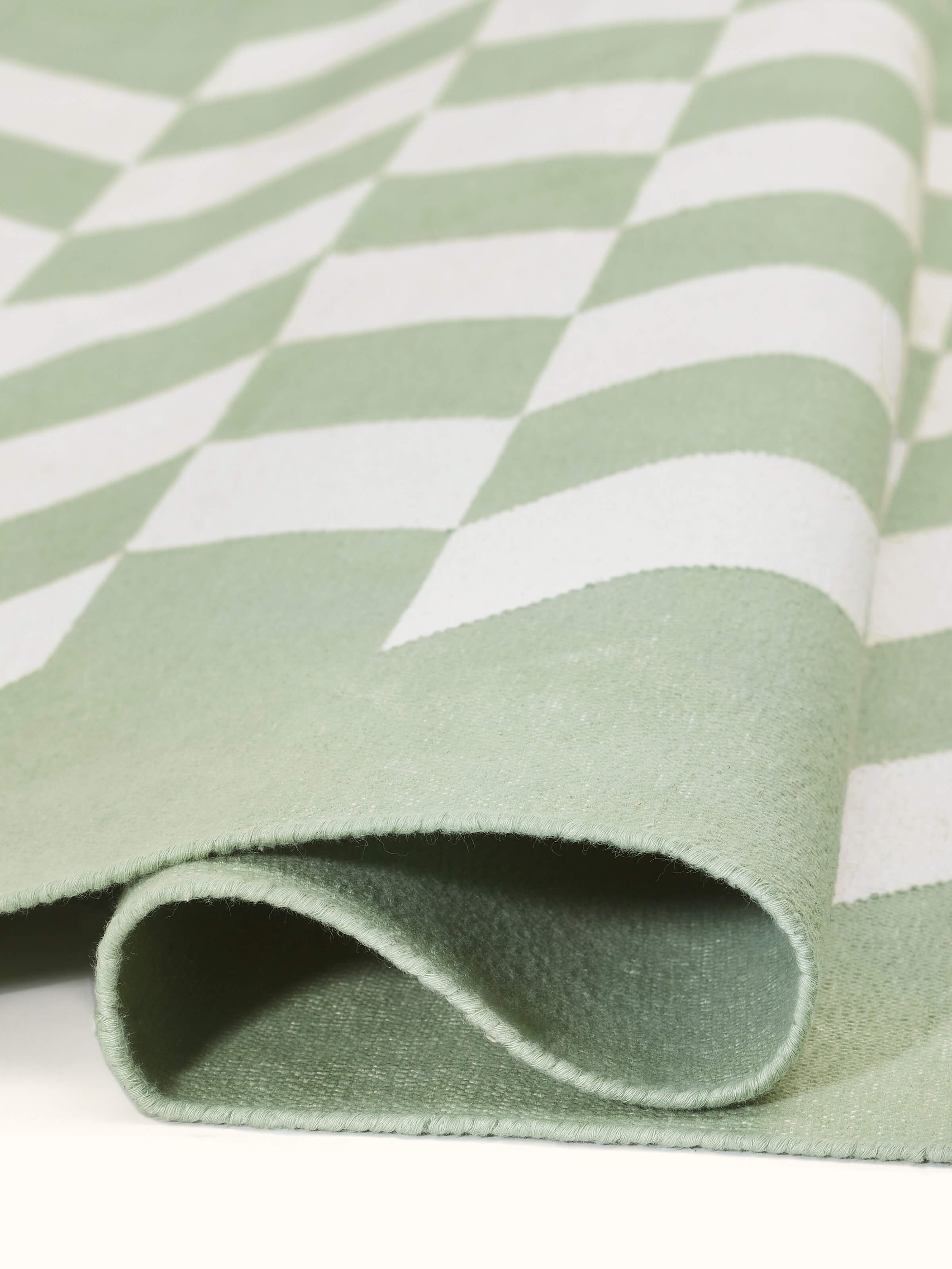 Modern geo chevron light green ivory lawan cotton panja dhurrie kharad arranged to show its full design and texture.