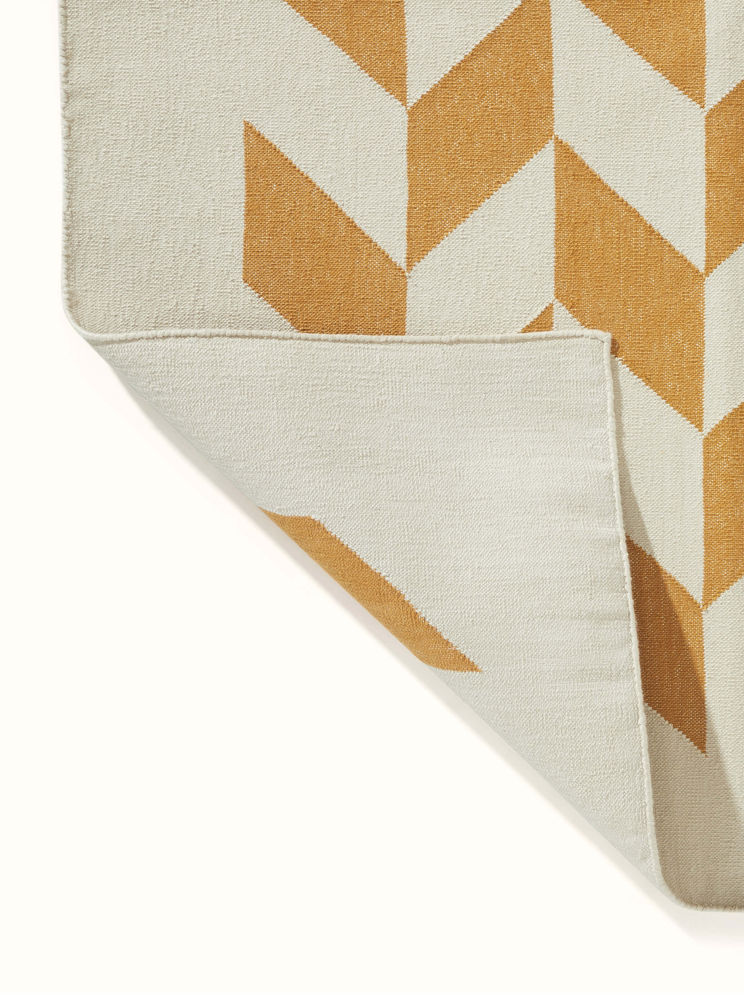 Modern Geo grey tan Lawan dhurrie folded, showing its compact and stylish design