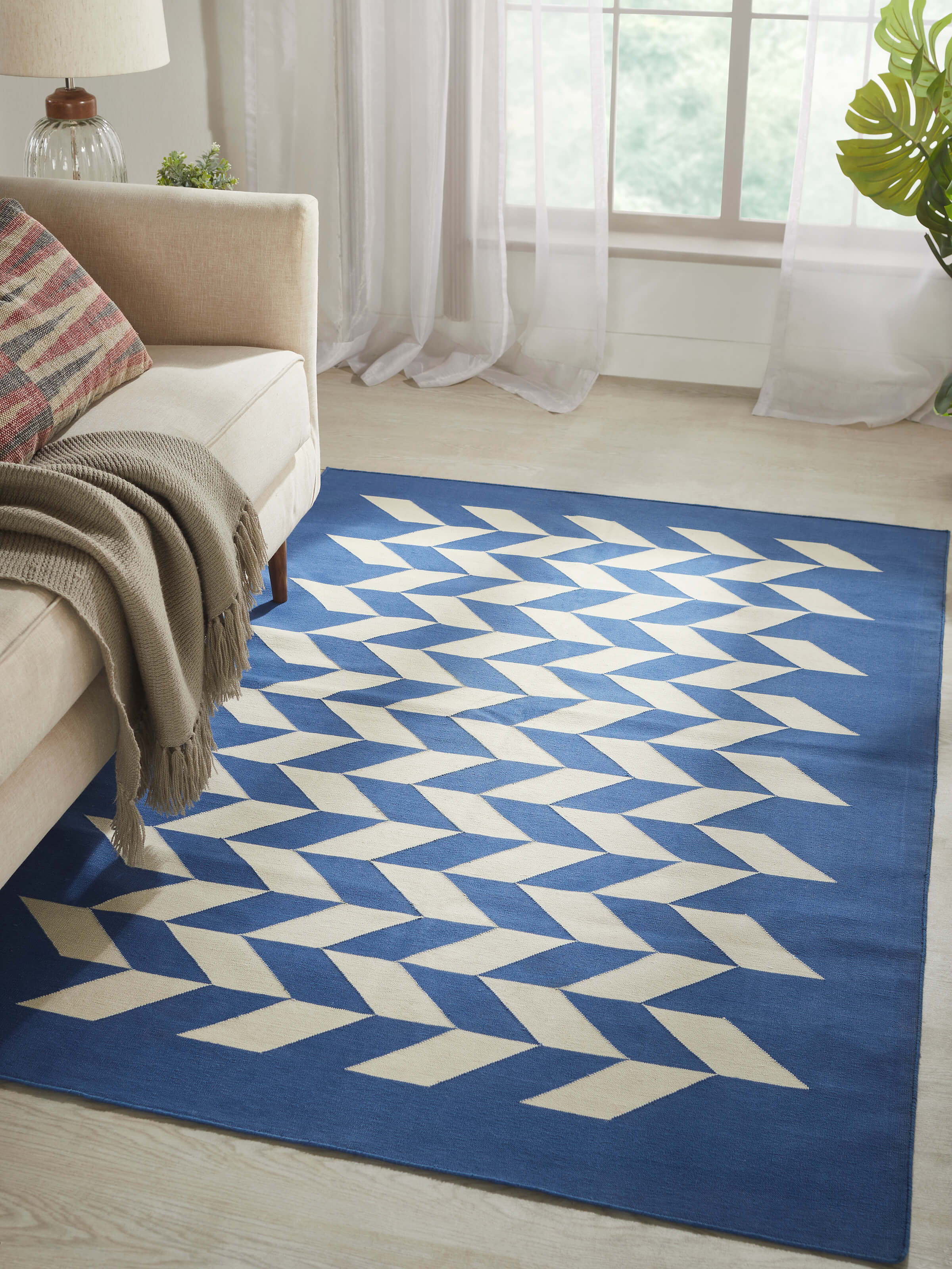 Close-up of Modern geo chevron blue ivory Lawan cotton Panja dhurrie, highlighting the chevron pattern and texture