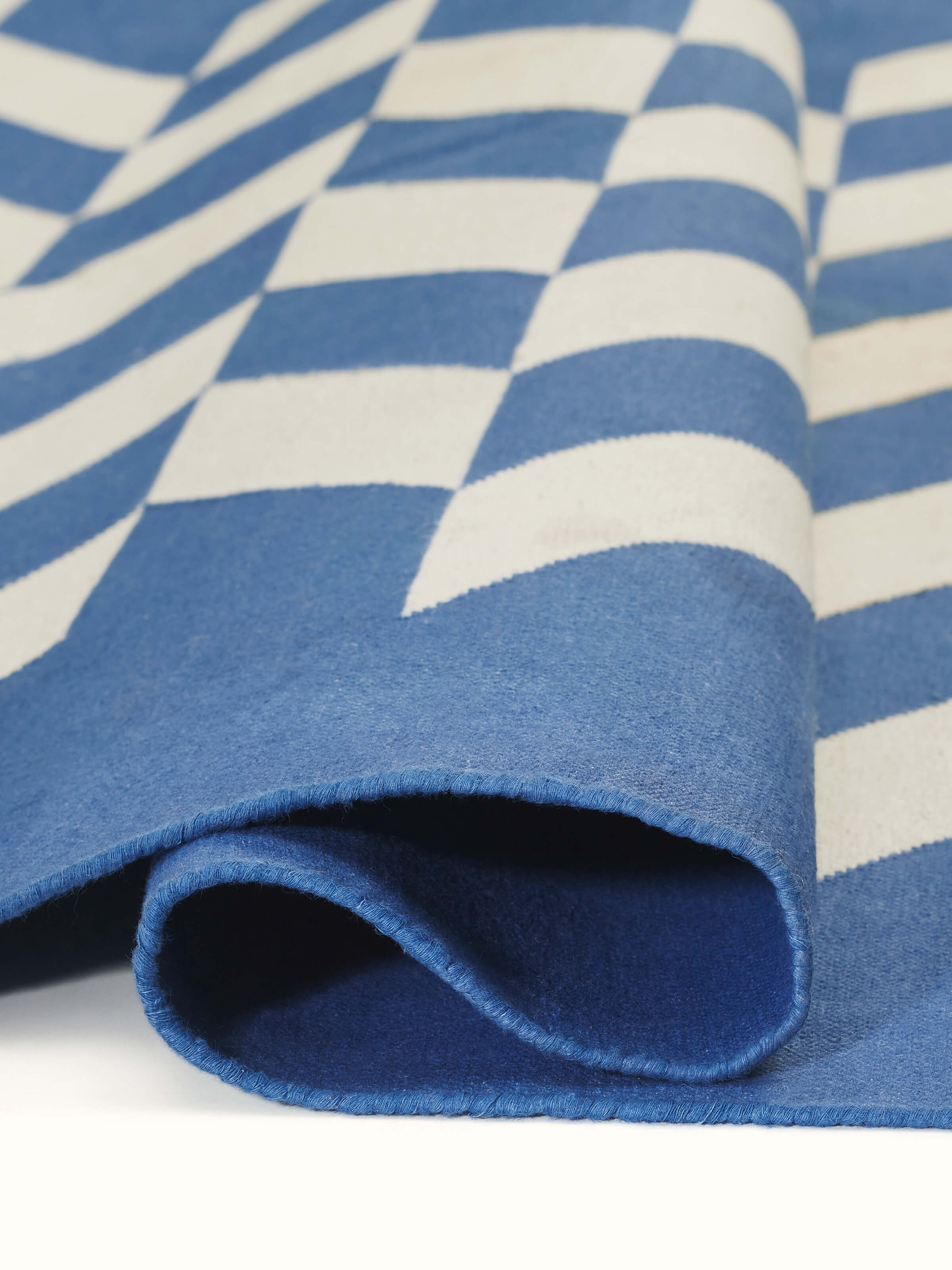 Detailed view of Modern geo chevron blue ivory Lawan cotton Panja dhurrie, focusing on the fabric and pattern