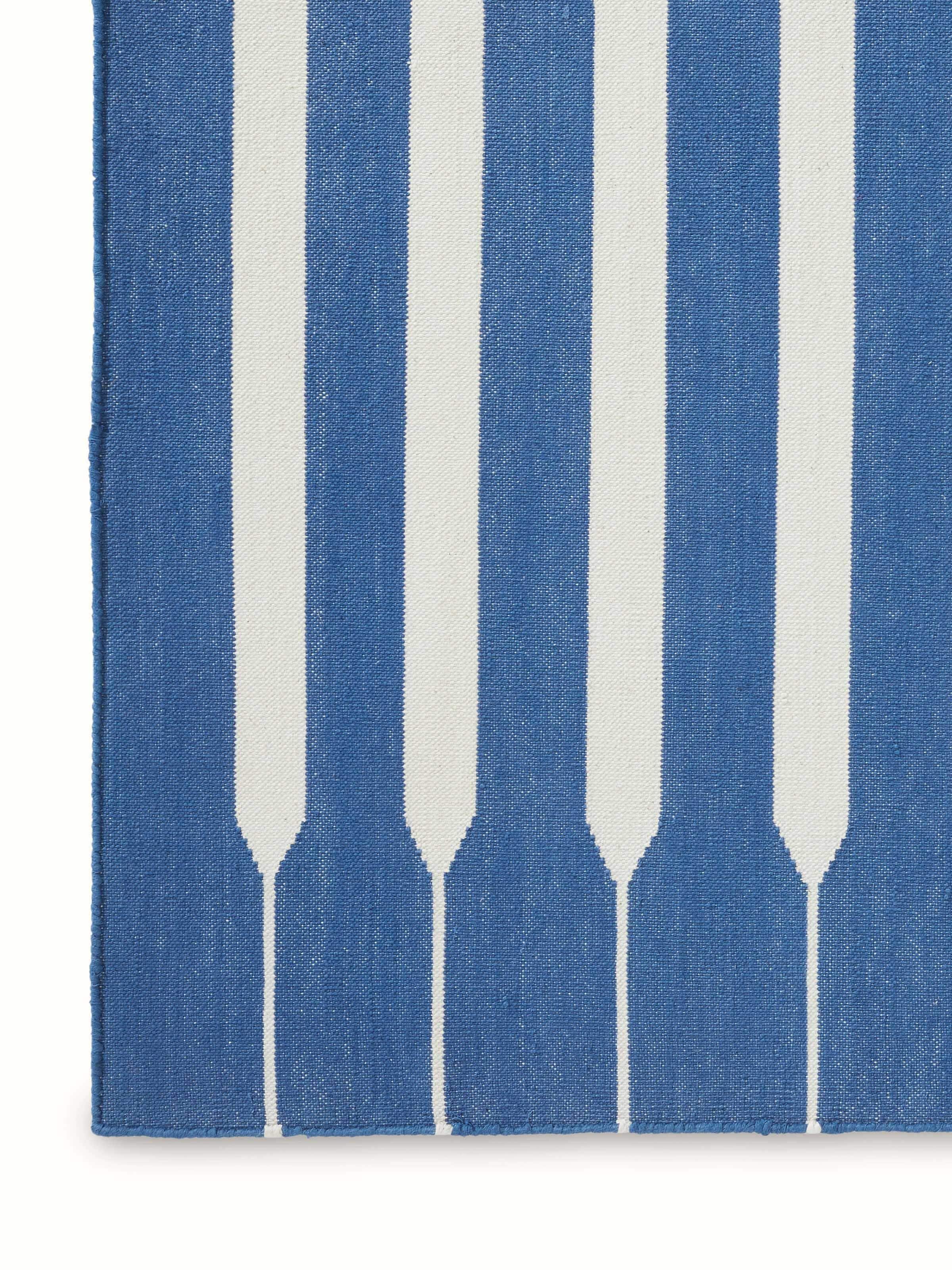 Detailed view of Modern geo stripe blue lawan cotton panja dhurrie emphasizing the quality of the cotton and stripe design.