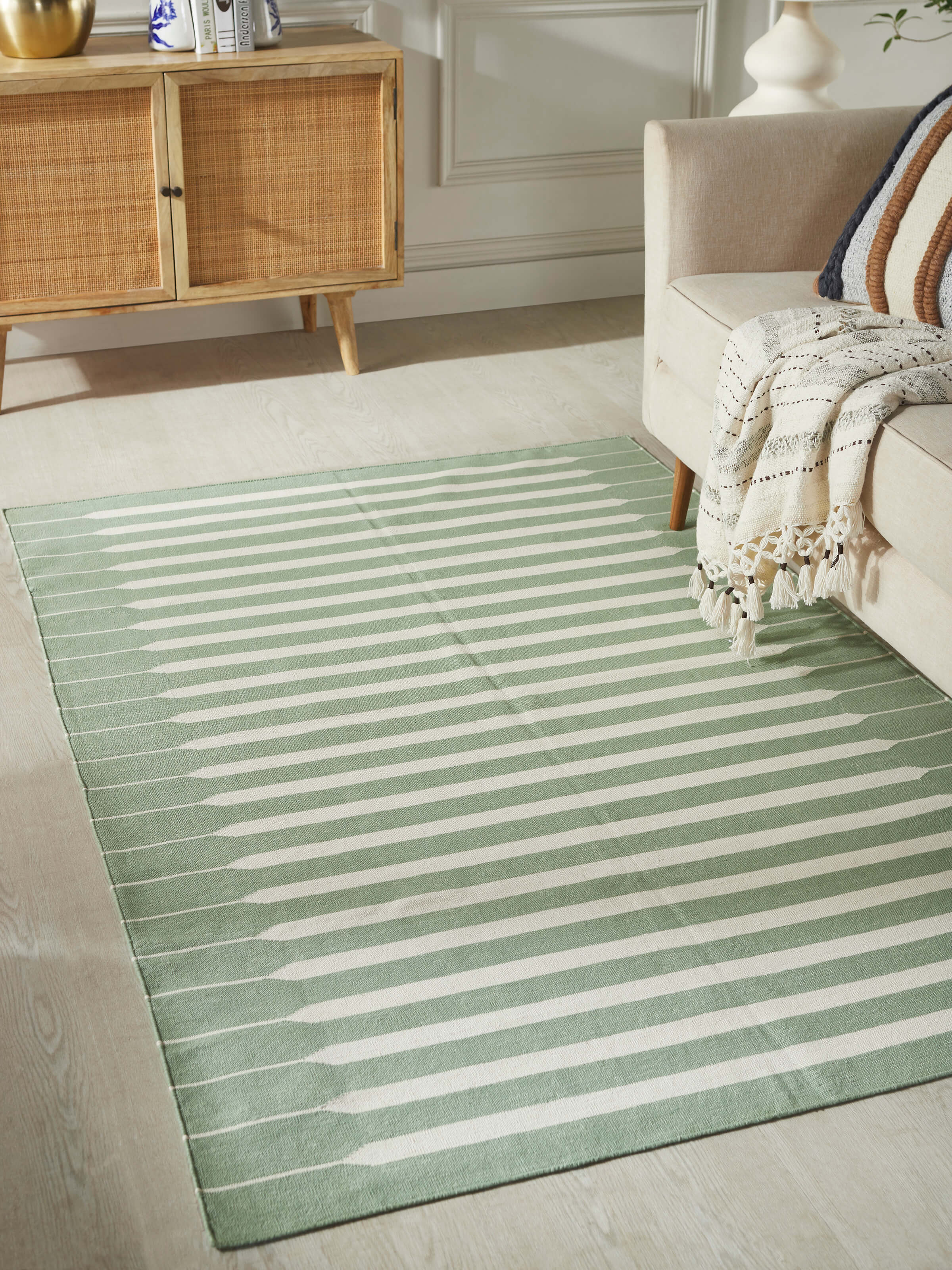 Close-up of Modern geo stripe light green ivory lawan cotton panja dhurrie kharad showing the detailed geometric stripes and fabric texture.