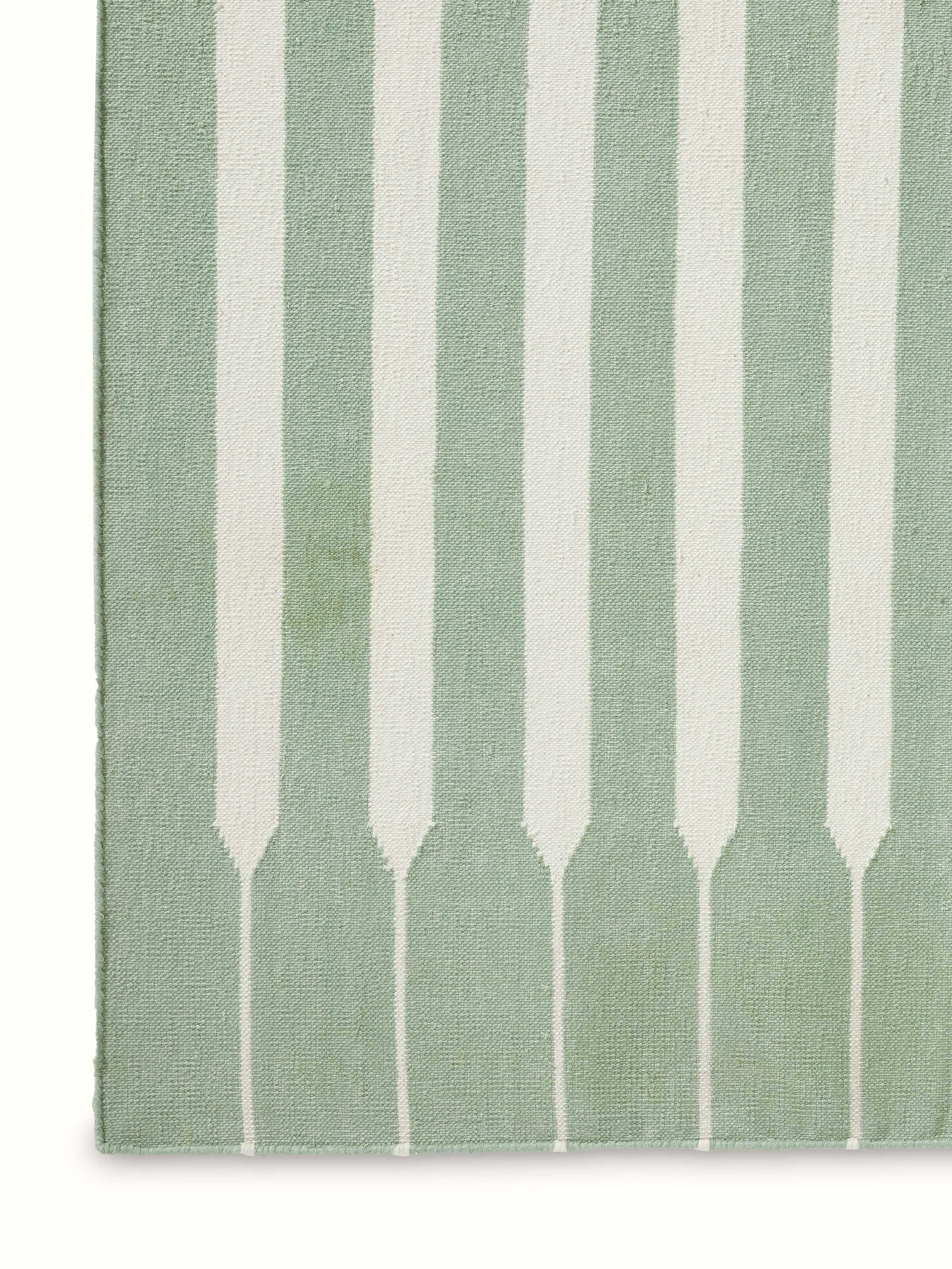 Detailed view of Modern geo stripe light green ivory lawan cotton panja dhurrie kharad showing the fine cotton weave and stripe patterns.